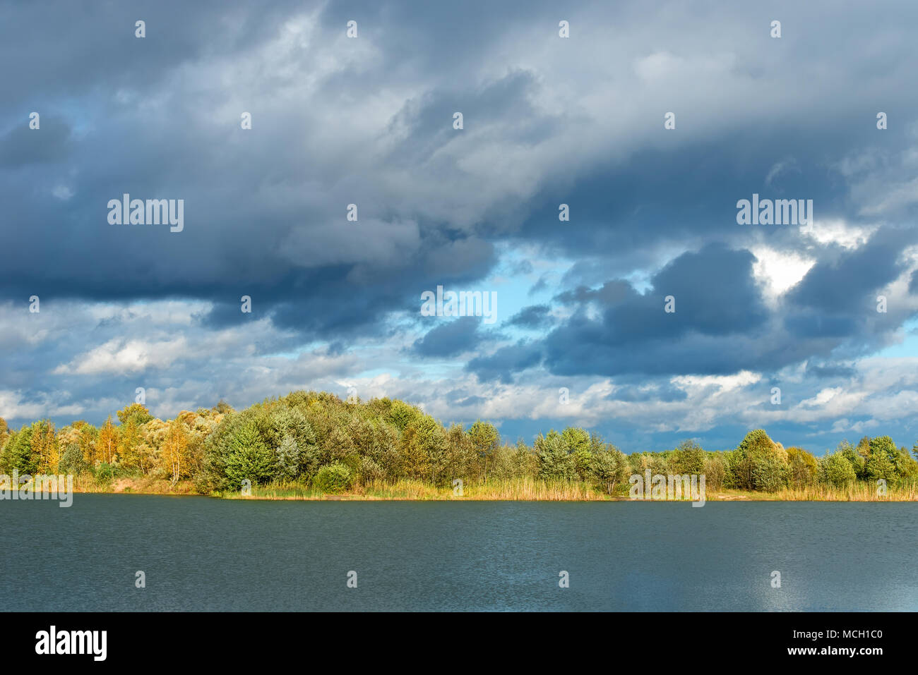 Autumn landscape. Autumn trees at the bank of the river in sunny autumn ...