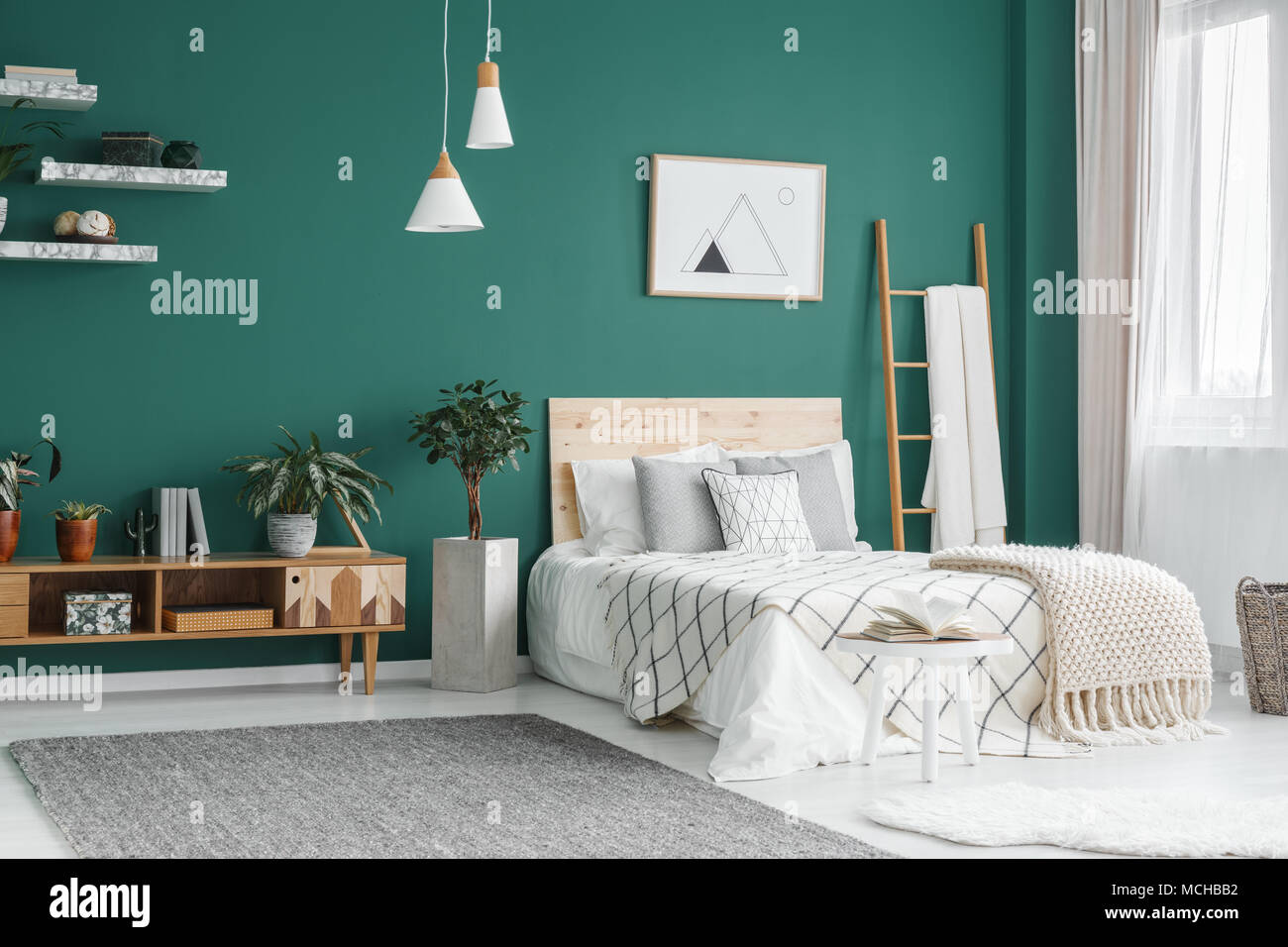 Bed Between Ladder And Plant In Green Boho Bedroom Interior