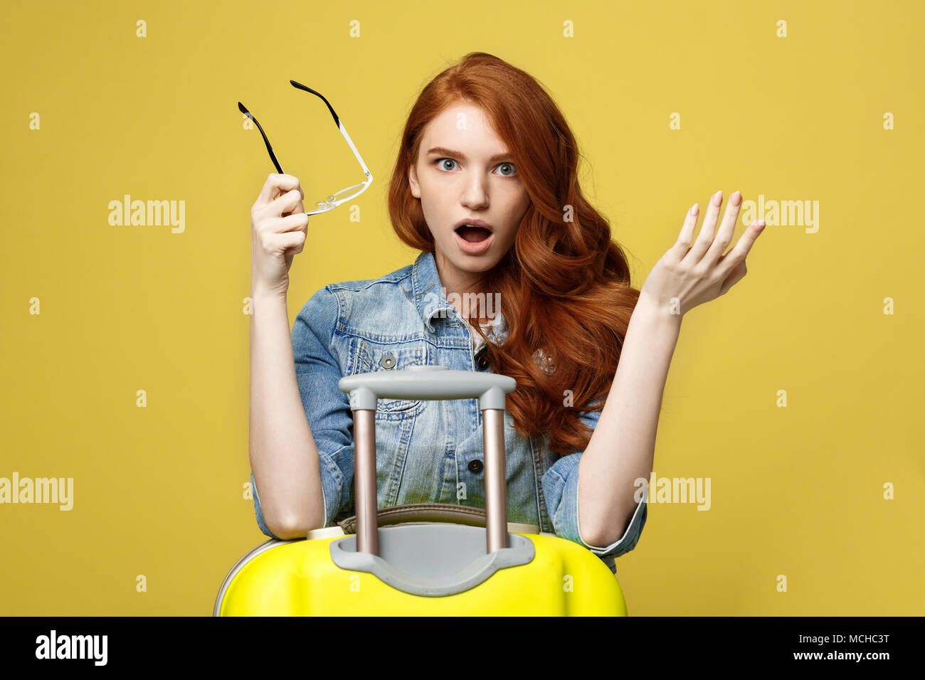 Travel and Lifestyle Concept: Portrait of a shocked girl in denim dress ...
