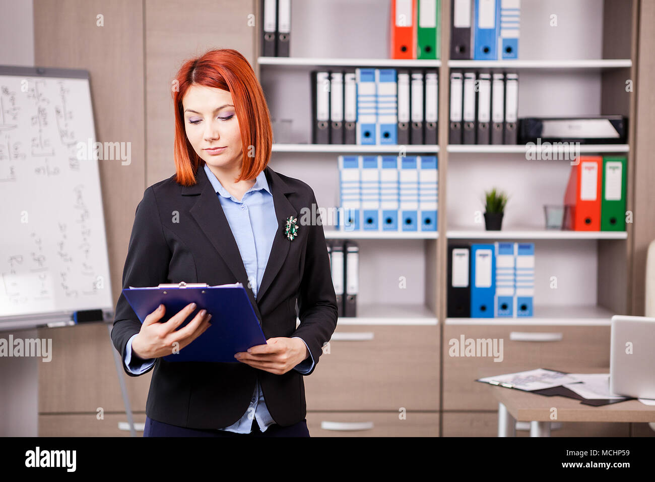 Businesswoman with a folder in hands Stock Photo - Alamy