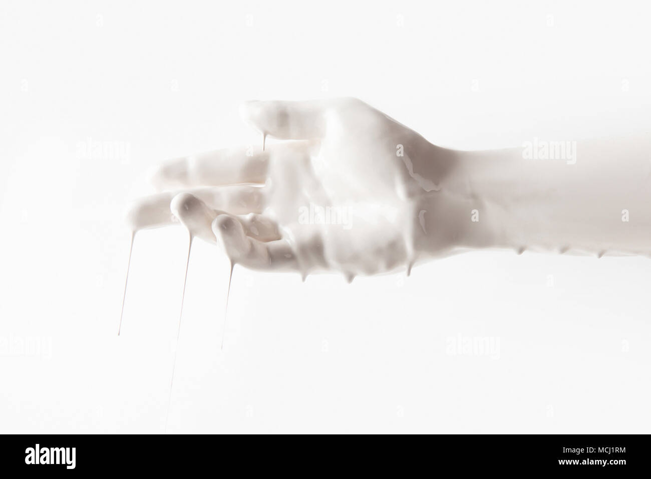 cropped image of female hand in white paint isolated on white Stock Photo