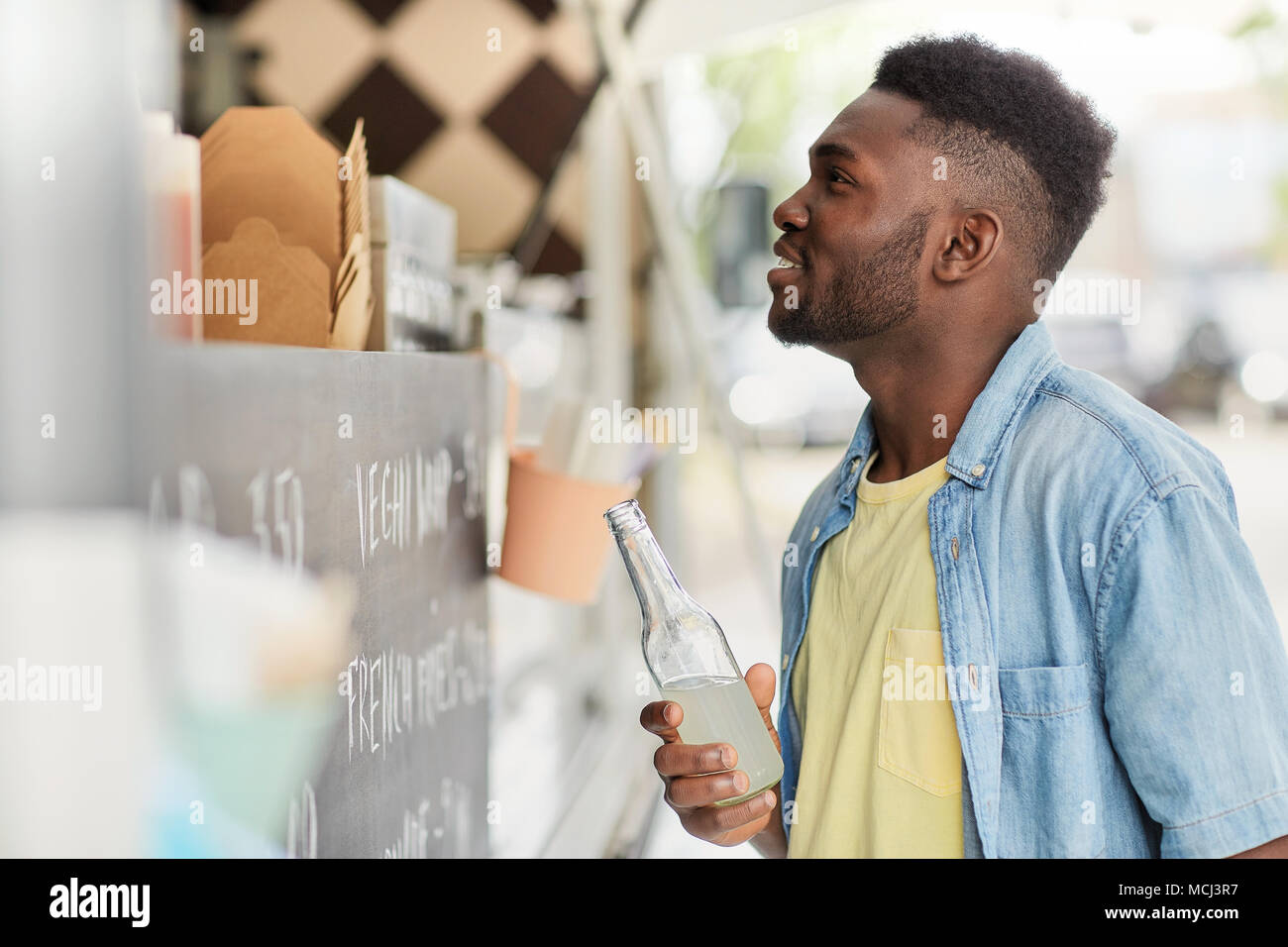 african american man with drink at food truck Stock Photo - Alamy
