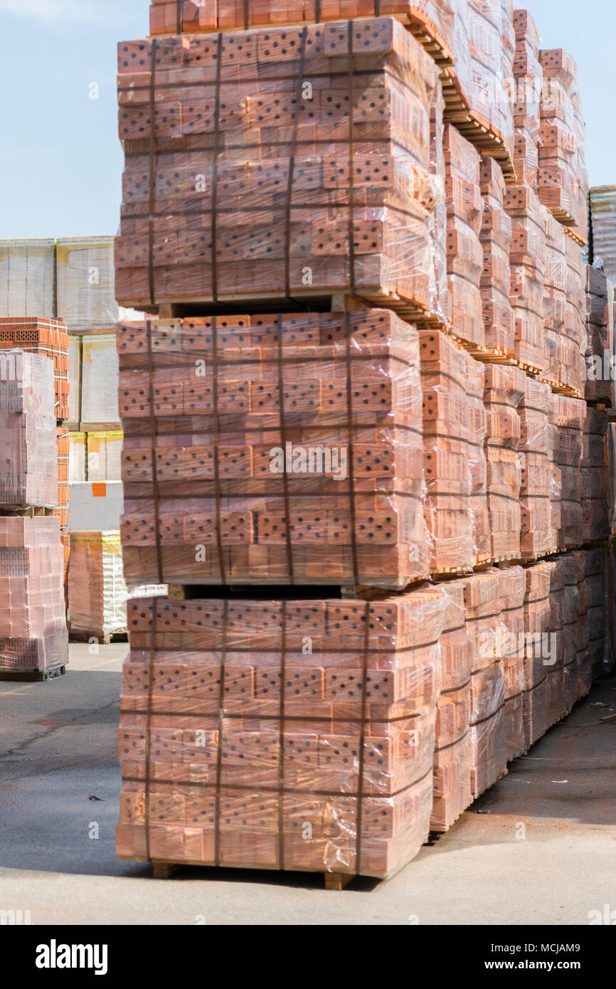 Several pallets with concrete brick stacked on top of each other in
