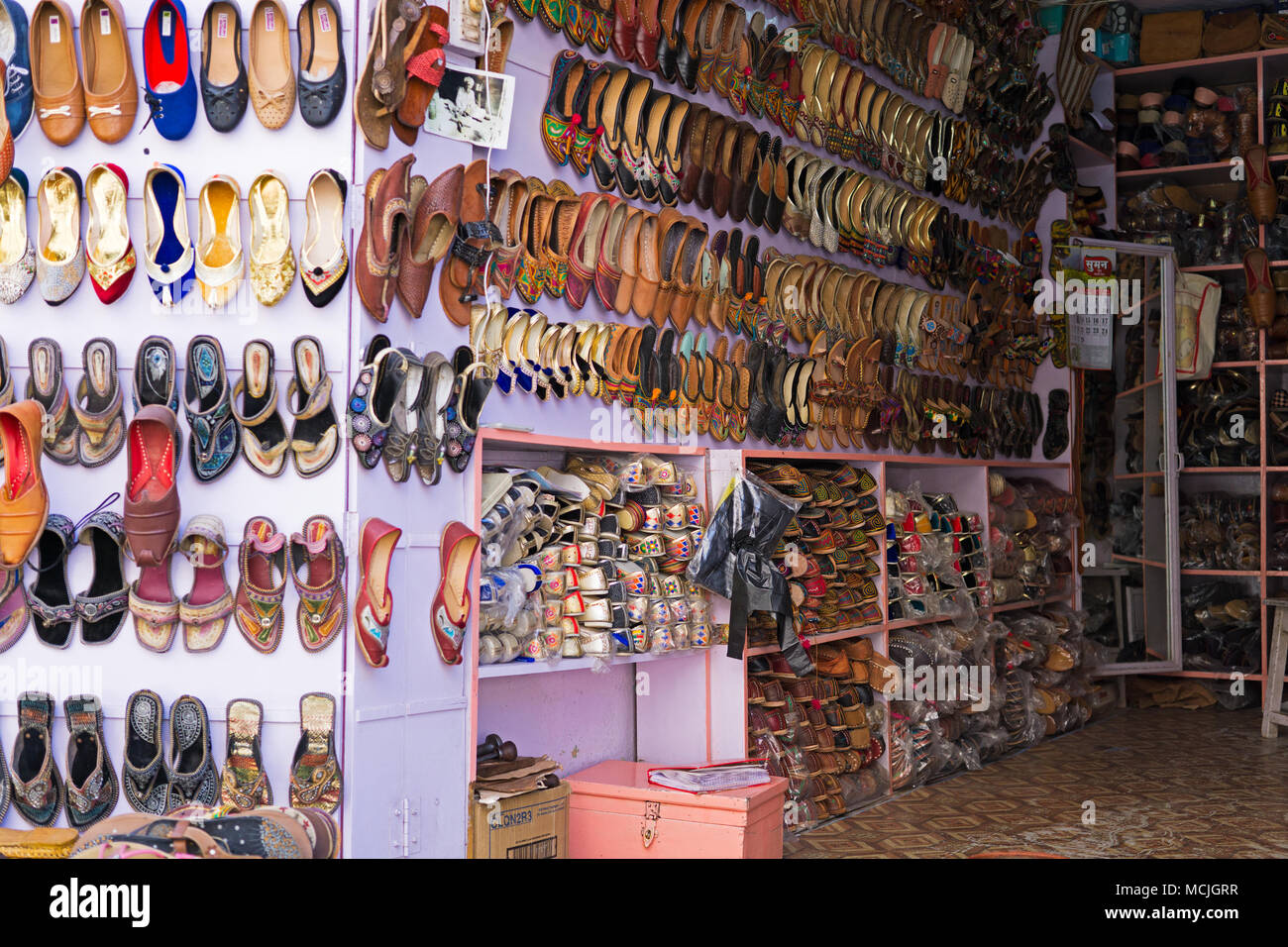 Mandawa, India - February 24, 2018: Shoe's shop with colorful shoes display in Mandawa town, Rajasthan. Stock Photo