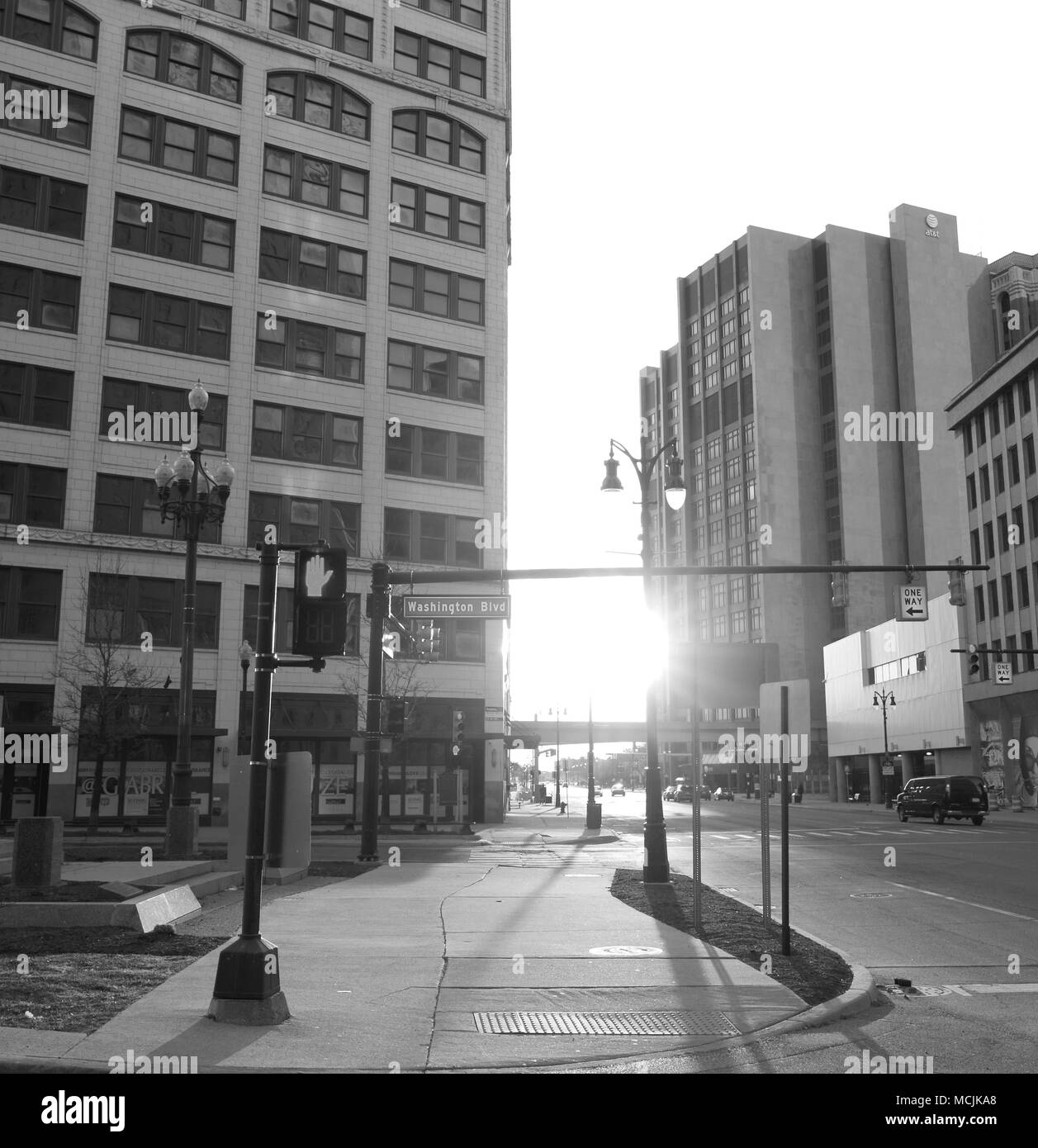 A black and white picture of an empty street and sidewalk in Detroit at the end of the day. Stock Photo