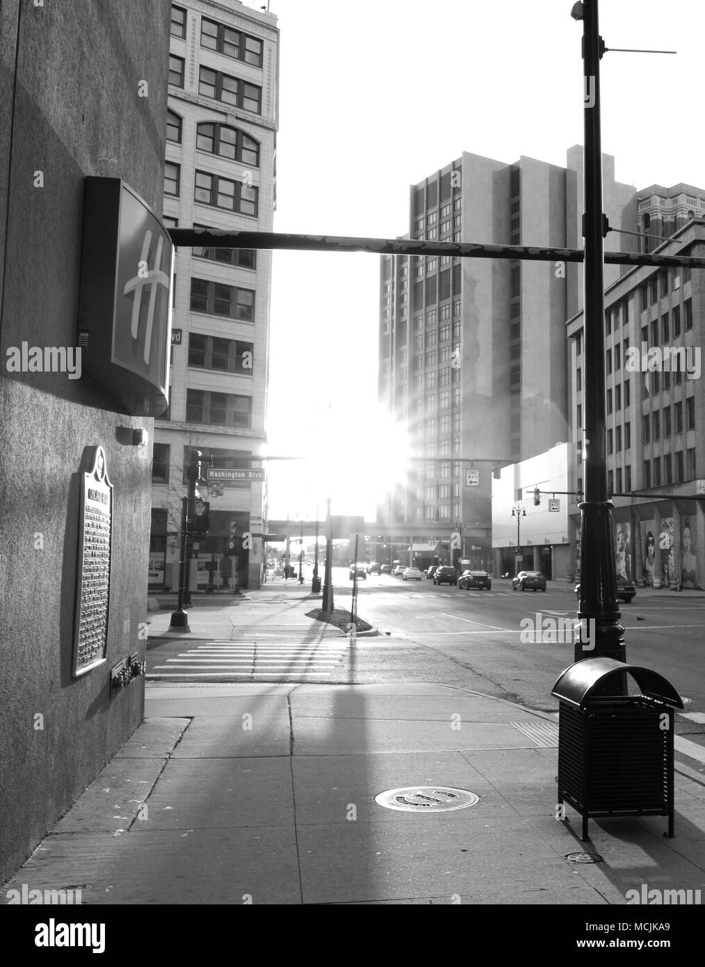 A black and white picture of an empty street and sidewalk in Detroit at the end of the day. Stock Photo