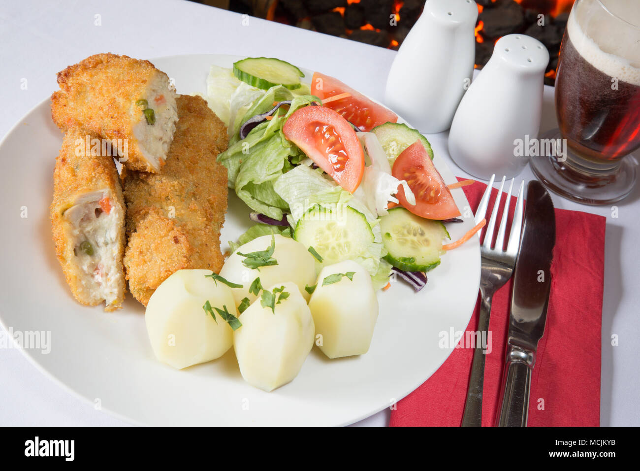 An English pub meal of deep fried breaded Chicken and vegetable