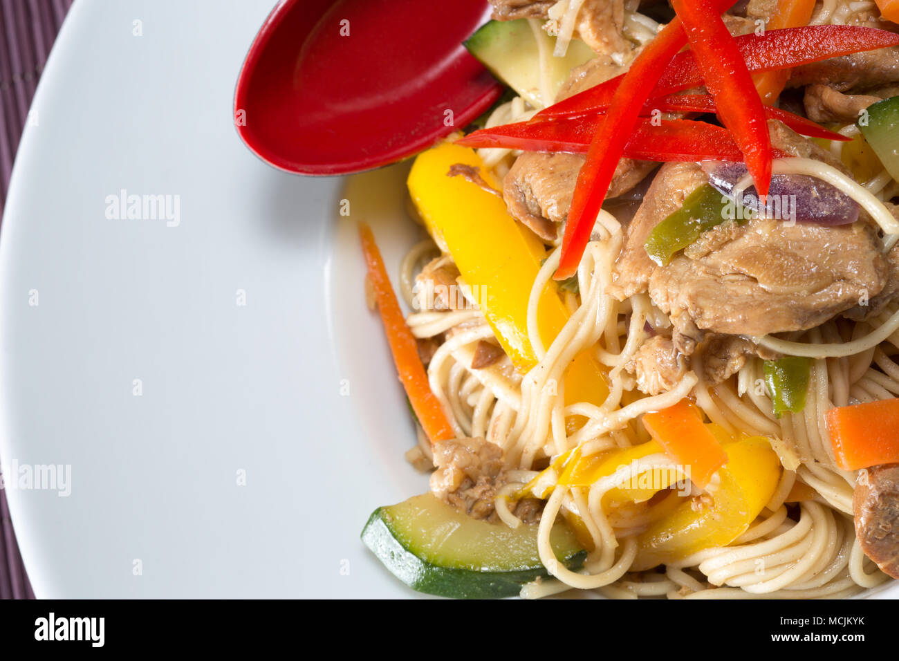 Chinese style Spicy Chicken and egg noodle stir fry Stock Photo - Alamy