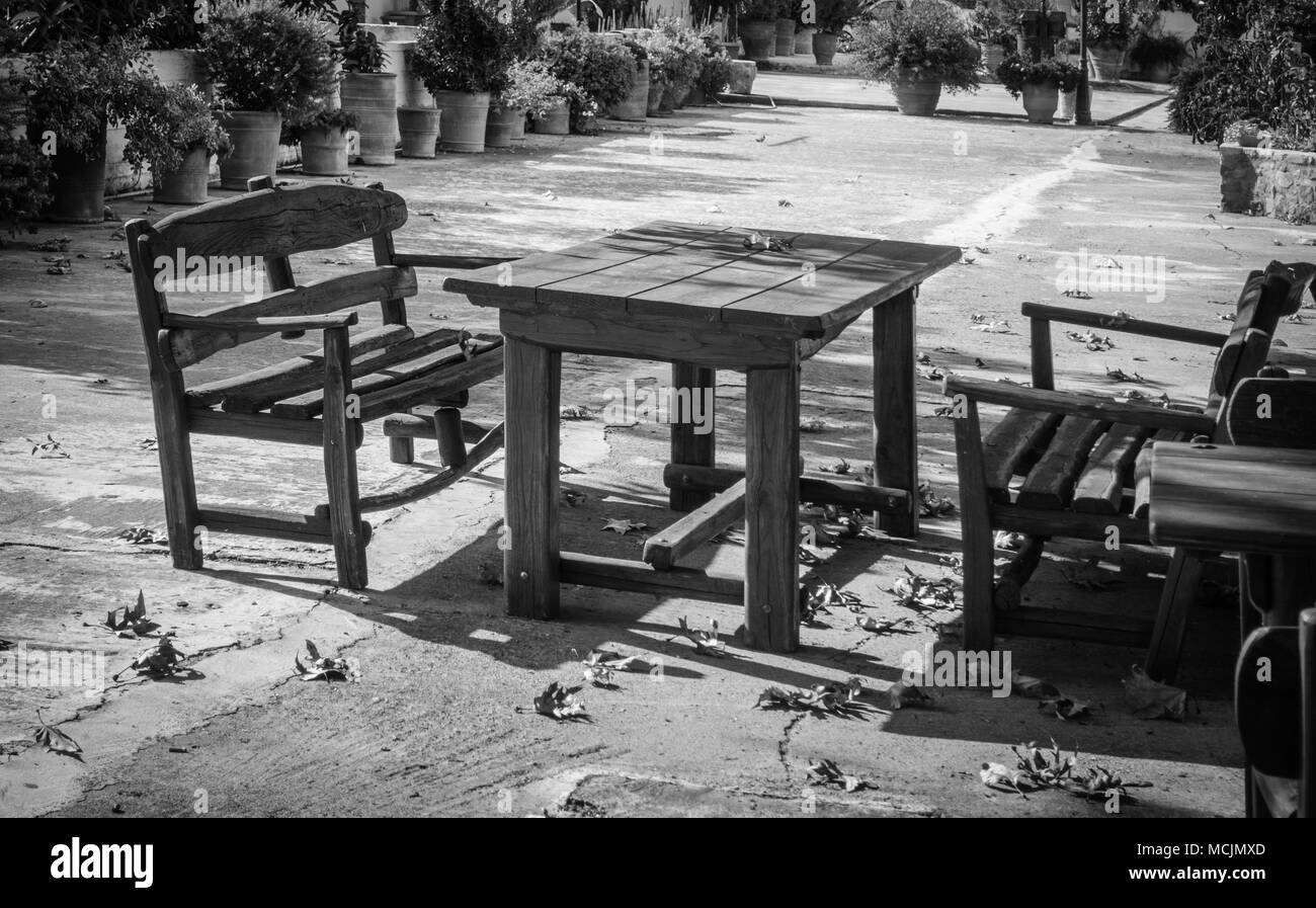 Side view of park bench and table under sunlight, Greece Stock Photo
