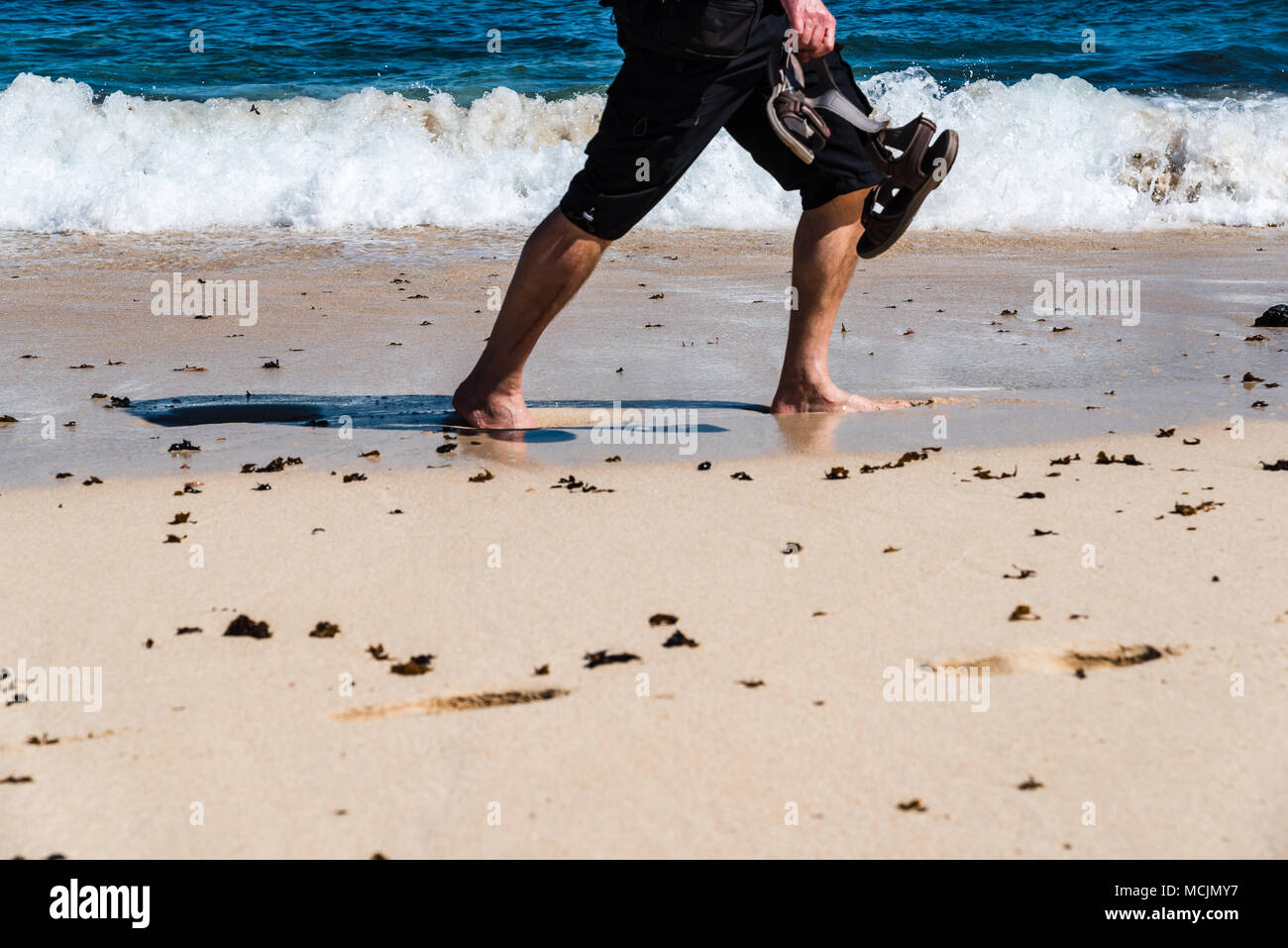 Man walking barefoot on beach hi-res stock photography and images - Alamy