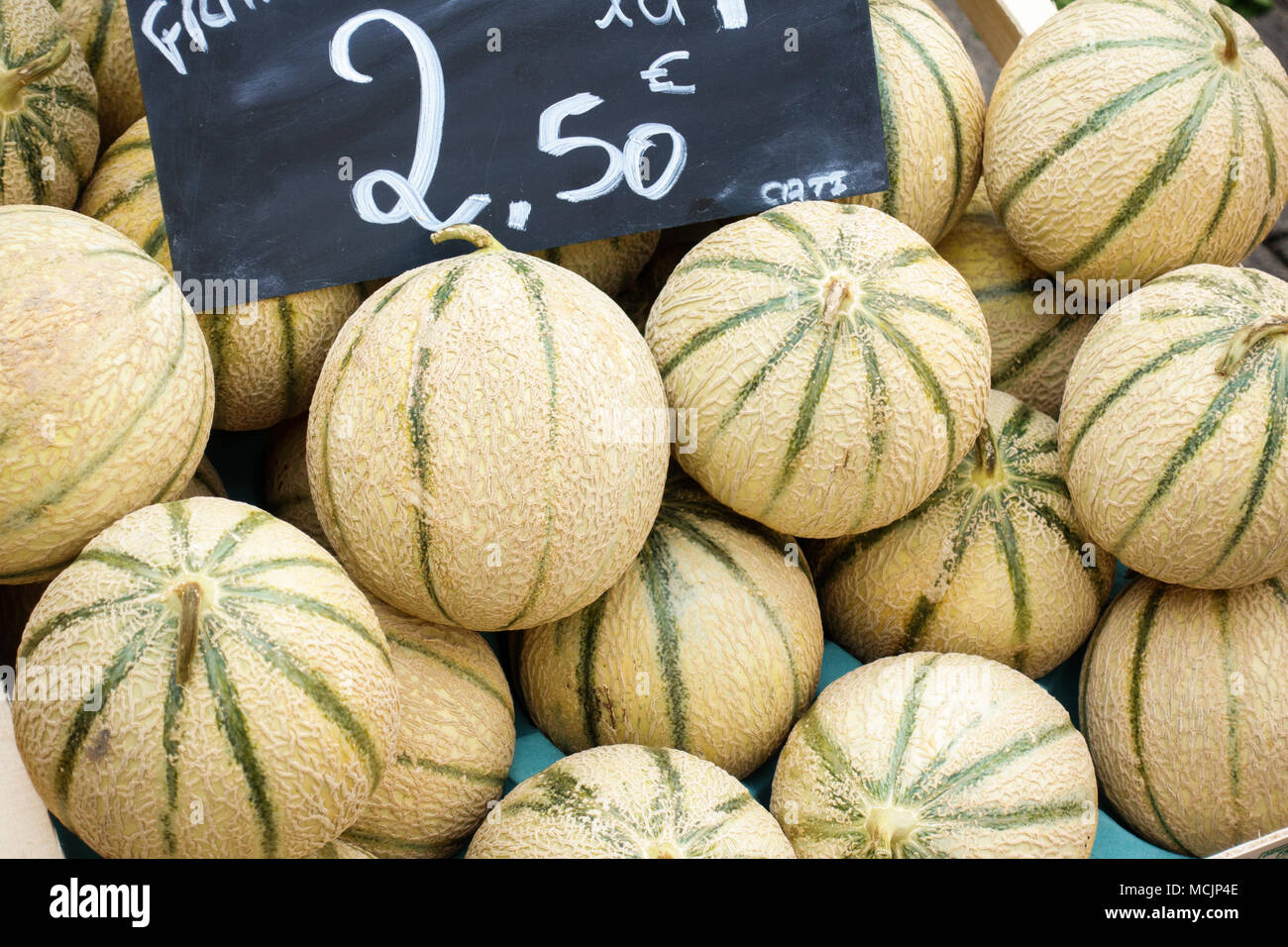 Cantaloupe melons in abundance for sale at market stall Stock Photo Alamy