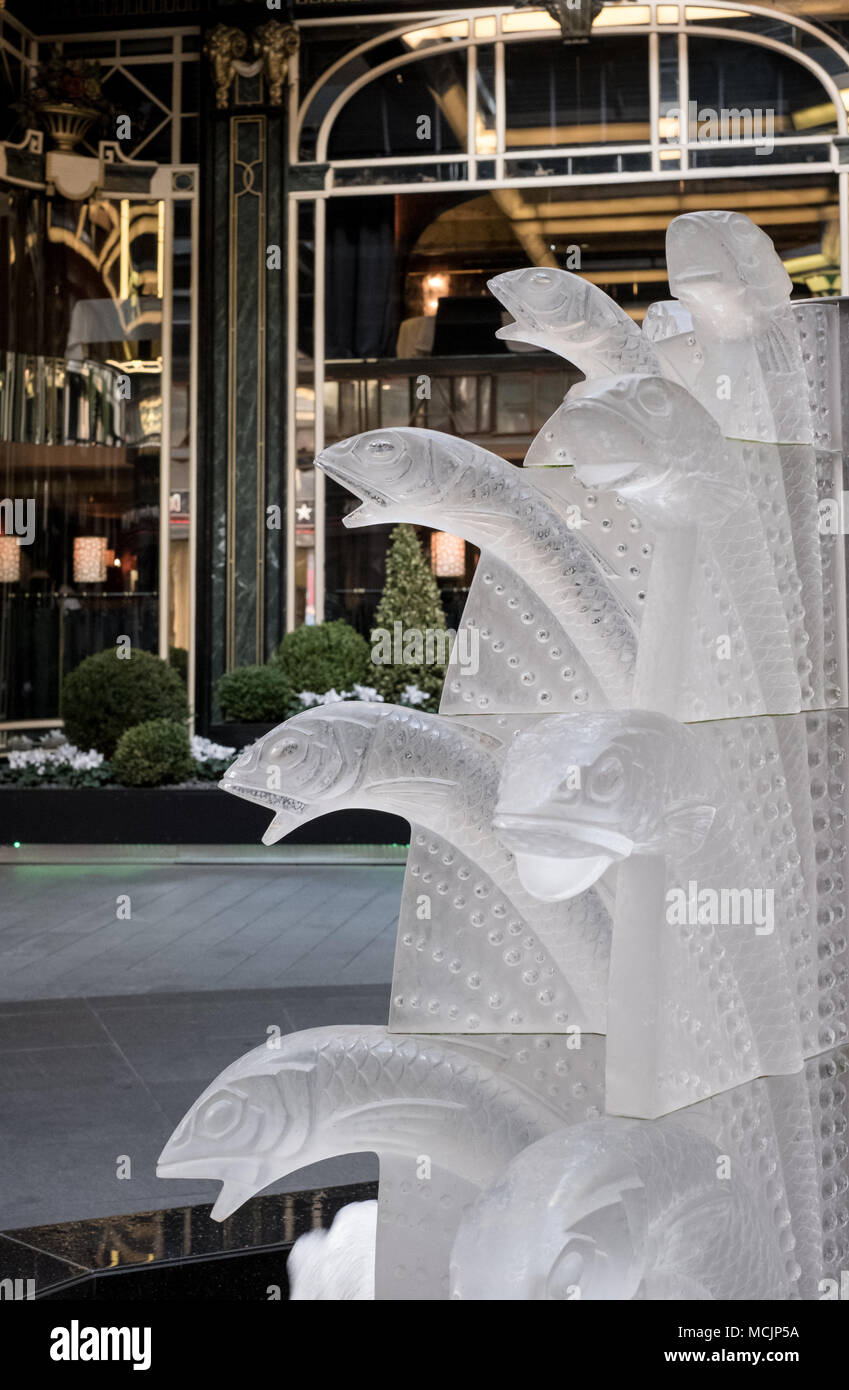 Close up of glass fountain with fish, located outside The Savoy Hotel