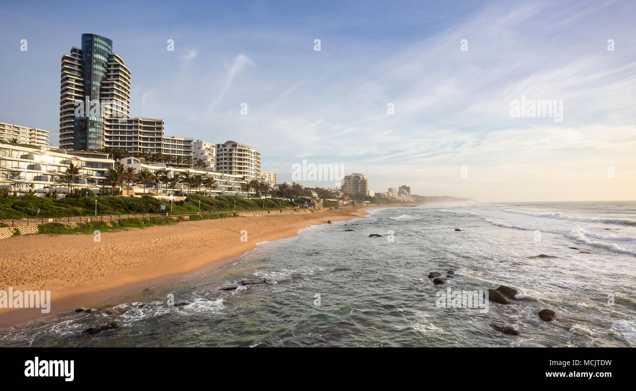 Durban, South Africa, April 9 - 2018: Seafront at dawn with holiday apartment buildings catching the sunlight. Stock Photo