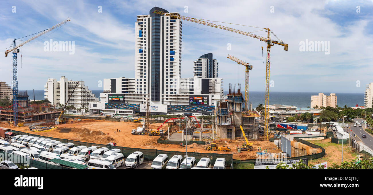 Durban, South Africa, April 9 - 2018: Construction site with construction cranes and the sea in the background. The site is part of a large scale apar Stock Photo