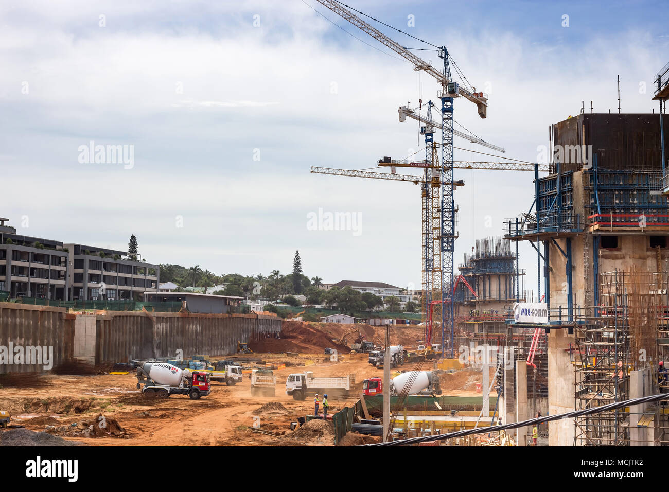 Durban, South Africa, April 9 - 2018: Construction site with construction cranes and cement trucks. The site is part of a large scale apartments devel Stock Photo