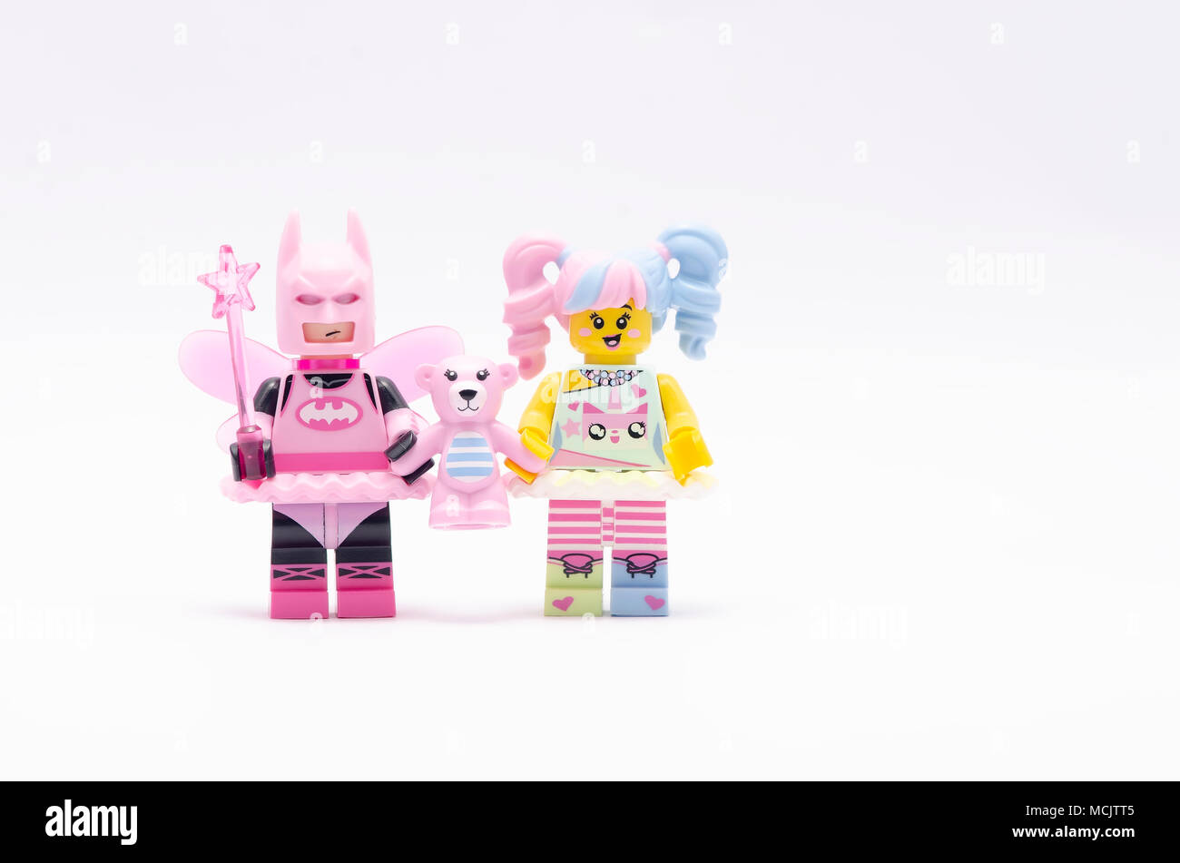 lego batman minifigure holding flower and pink teddy bear Stock Photo -  Alamy