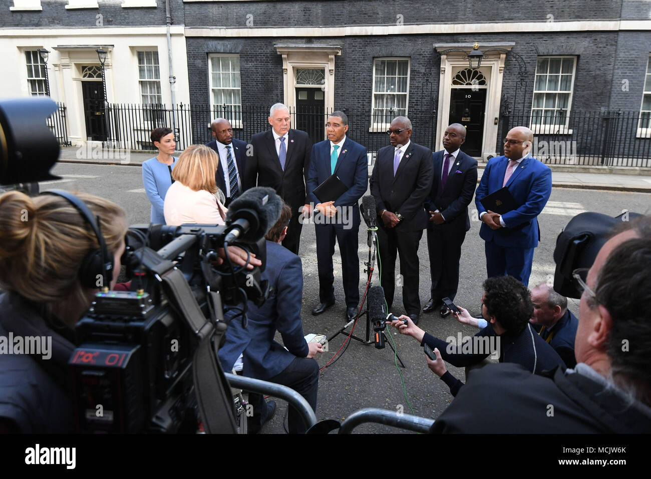 The Prime Minister of Jamaica Andrew Holness, with other members of the delgation, talks to the waiting media in Downing Street after the meeting with Prime Minister Theresa May in relation to the Windrush generation immigration controversy. Stock Photo