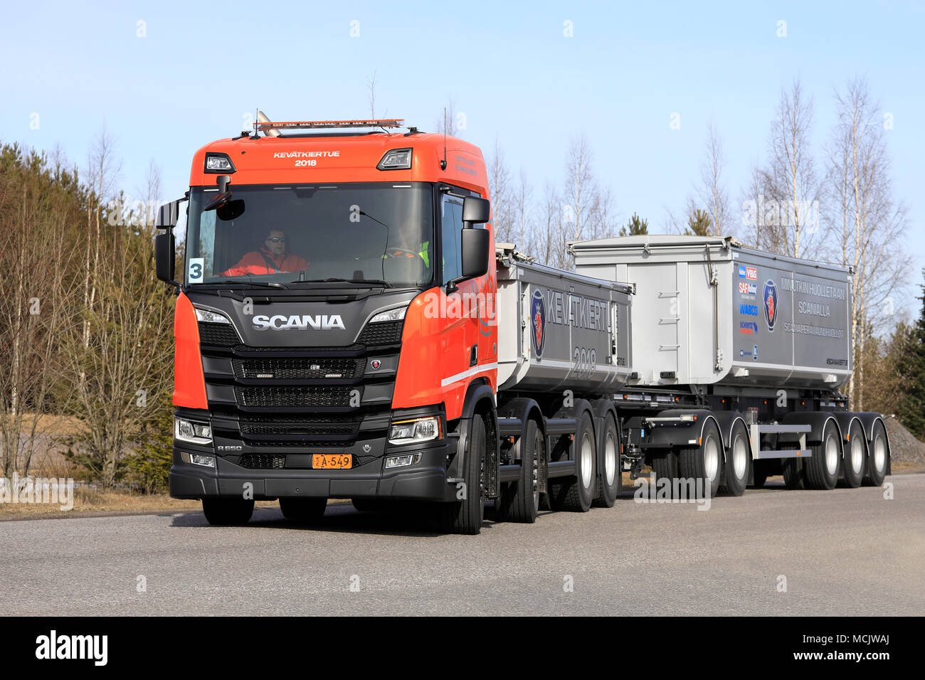 LIETO, FINLAND - APRIL 12, 2018: Orange Scania R650 B8X4 gravel truck combination on test drive during Scania Tour 2018 in Turku. Stock Photo