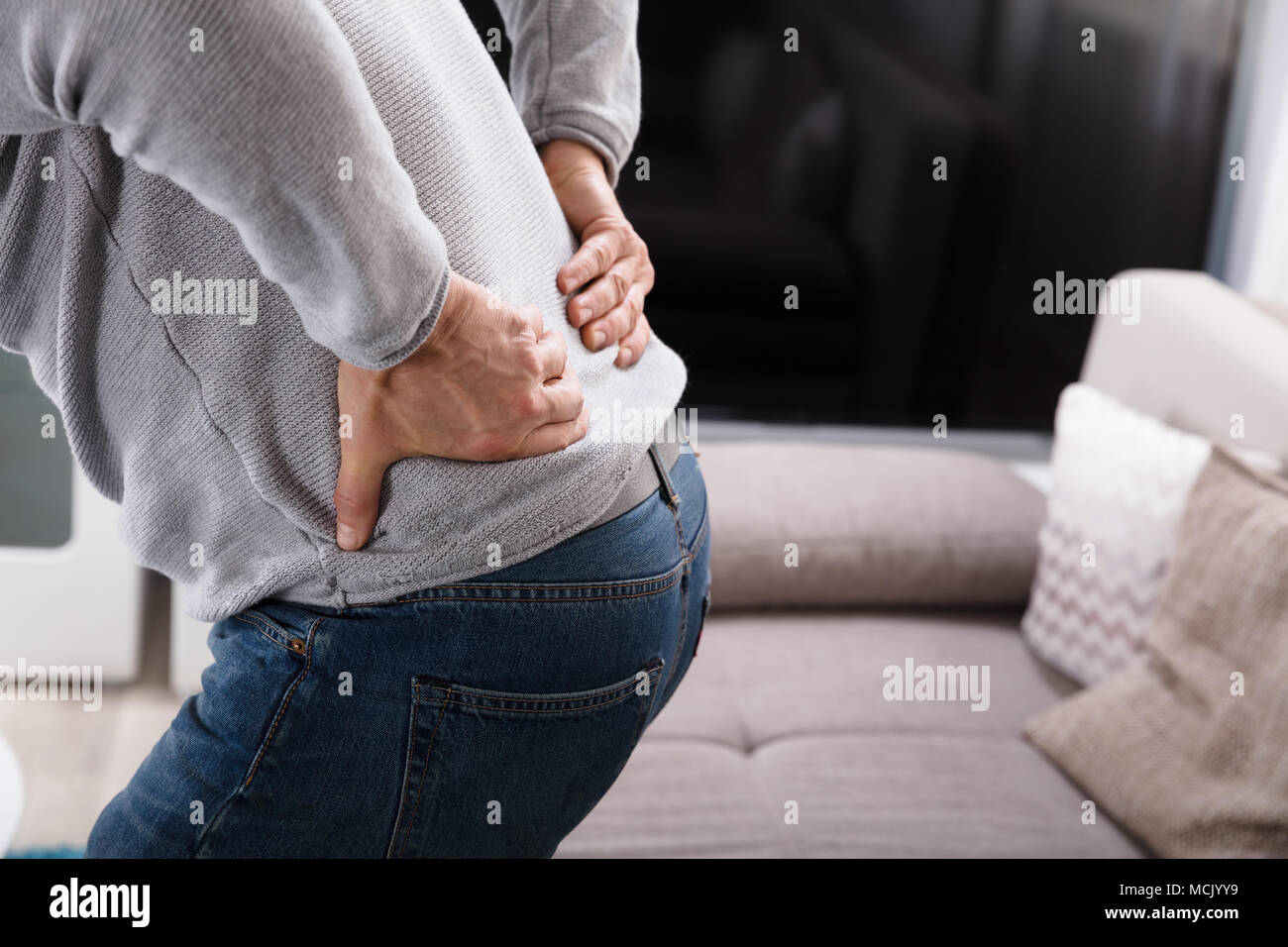 Mid Section View Of A Man Suffering From Back Pain Stock Photo