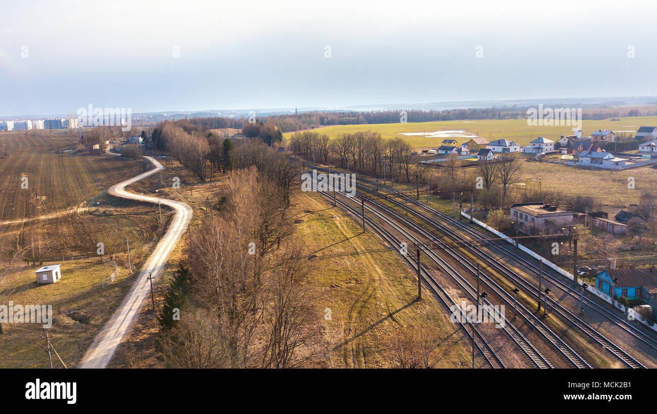 Top perspective view on railway lines. Spring fields. Aerial view of railway station. Stock Photo