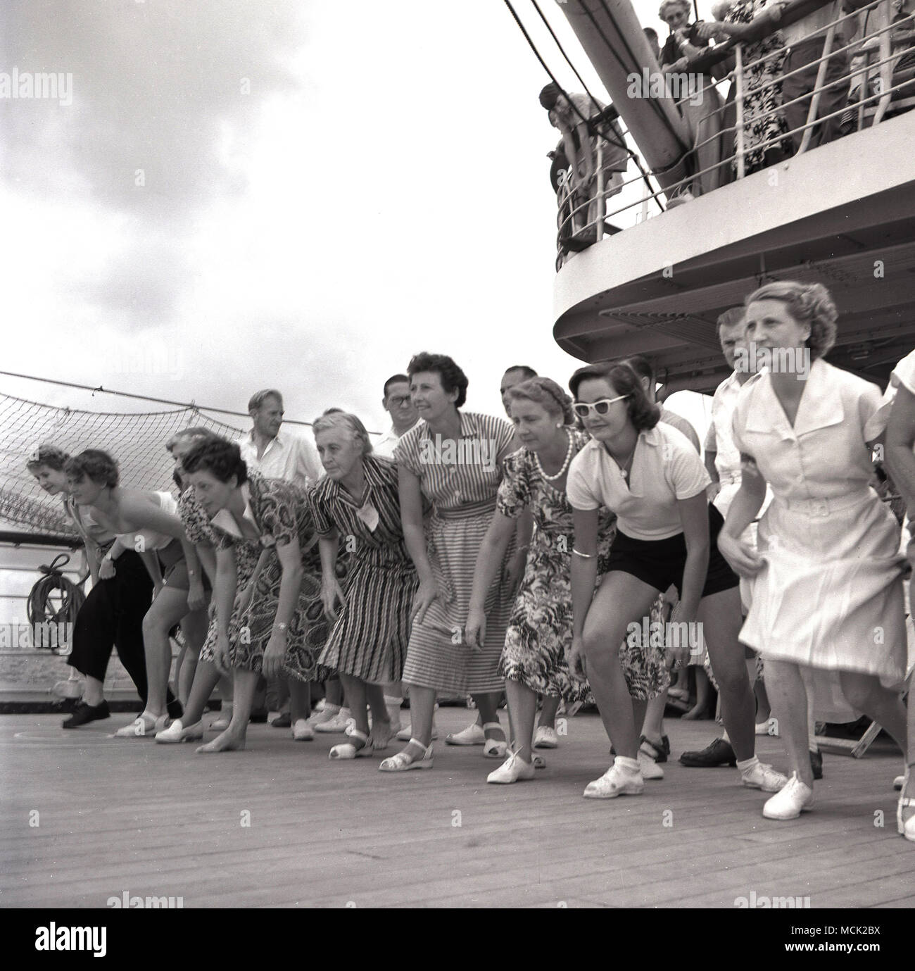 1961, historical, female passengers line-up ready to take part in a running deck game on-board the RMS Windsor Castle mailship on route to the Cape in South Africa. Stock Photo