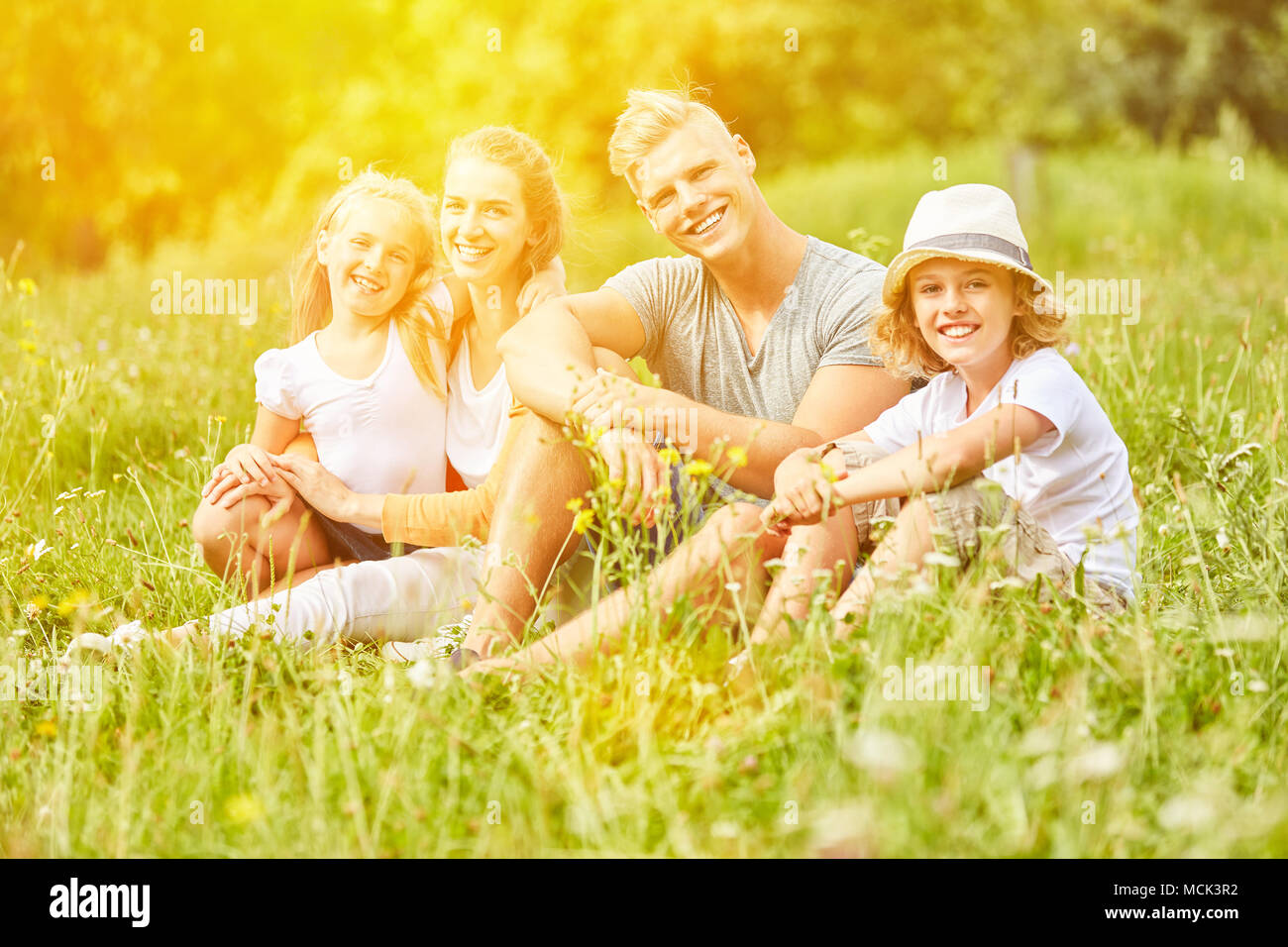 Happy family is looking for relaxation on vacation in summer on a meadow Stock Photo