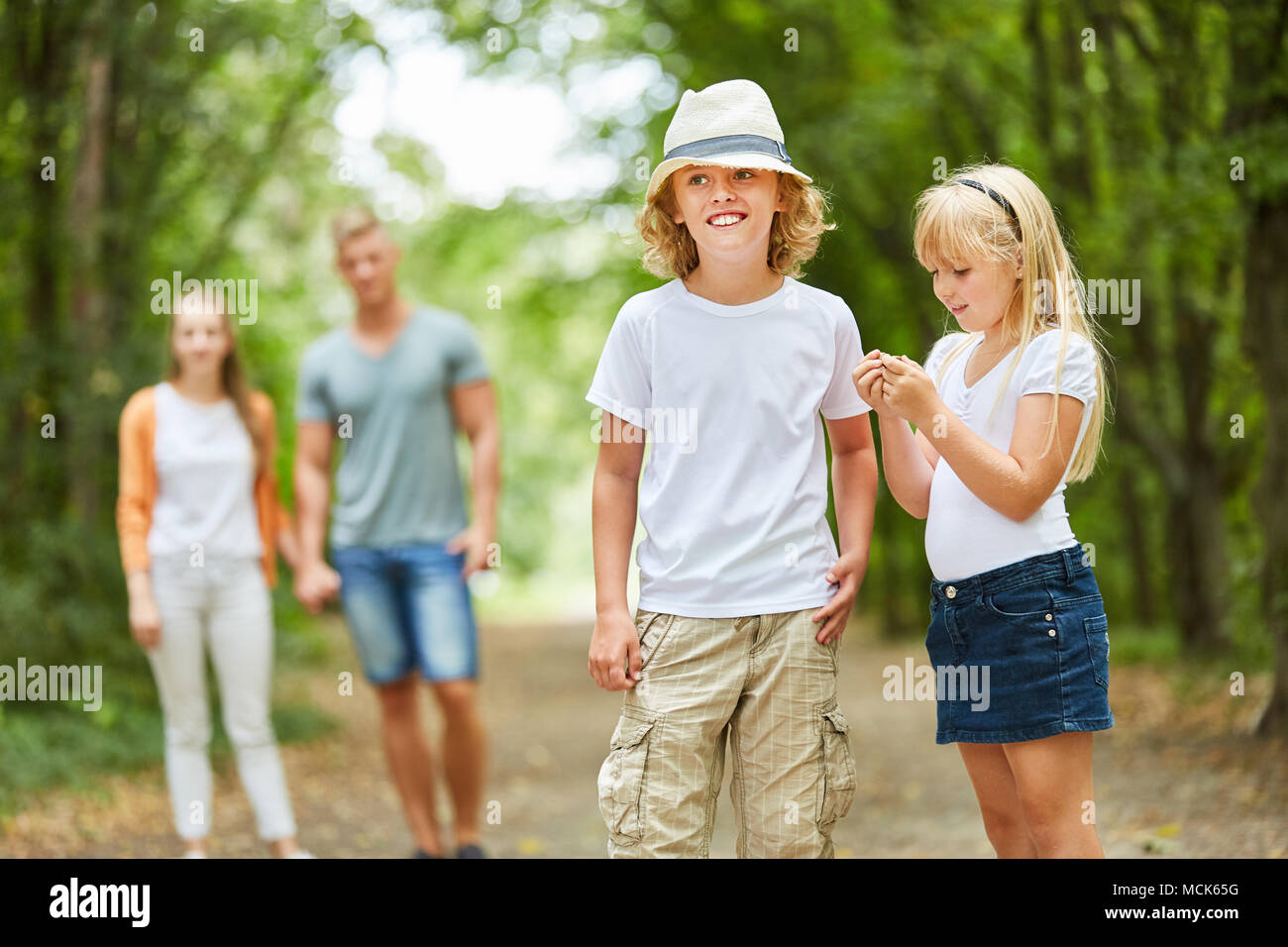 Siblings Children and parents go on a nature trip Stock Photo