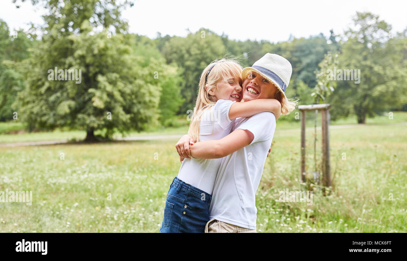 Happy girl hugs happy her boyfriend or brother in the summer Stock ...
