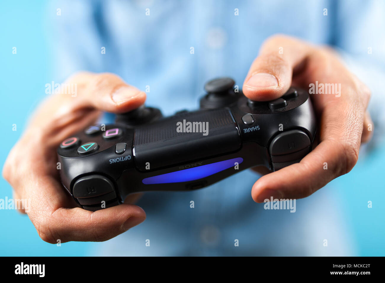 Male hands holding a PS4 controller Stock Photo Alamy