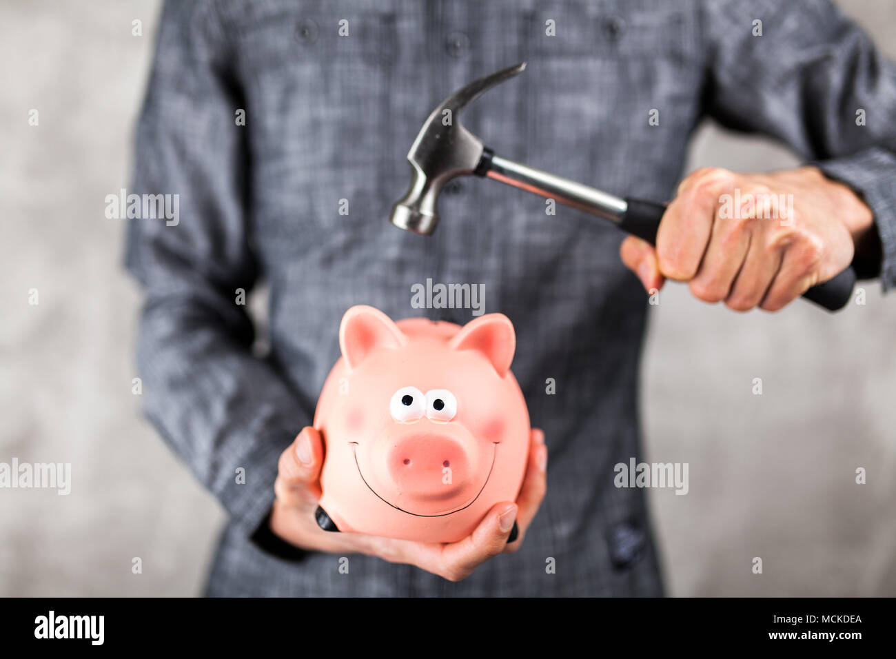 Man piggy bank hammer hi-res stock photography and images - Alamy