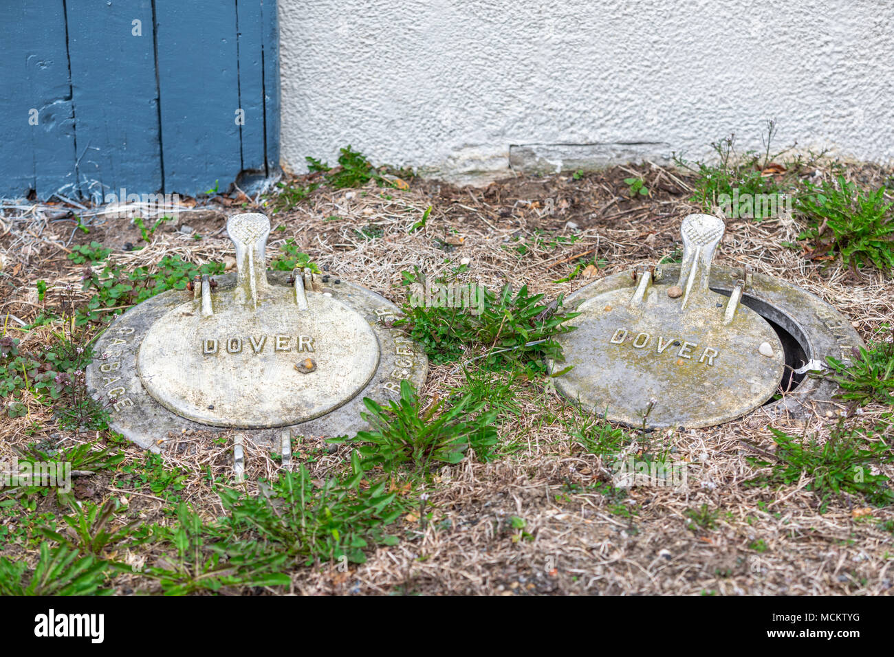 old in ground garbage cans with lids Stock Photo - Alamy