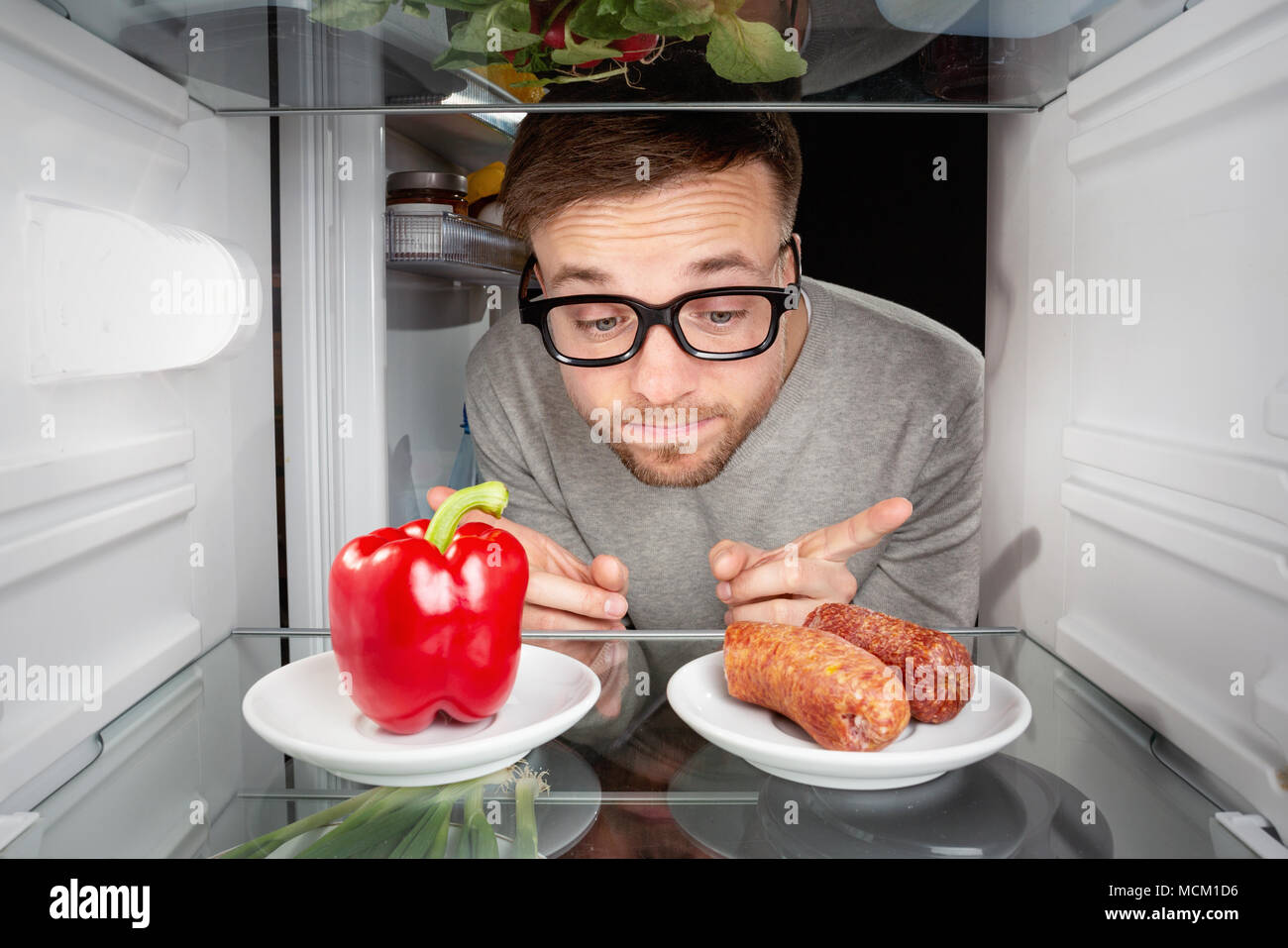 Choosing between vegetable and meat Stock Photo Alamy