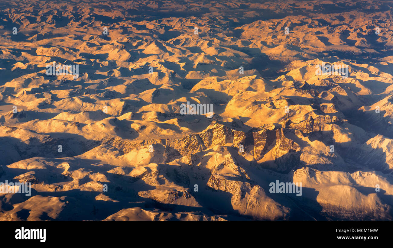 Aerial view of snowy mountain at sunset in winter Stock Photo - Alamy