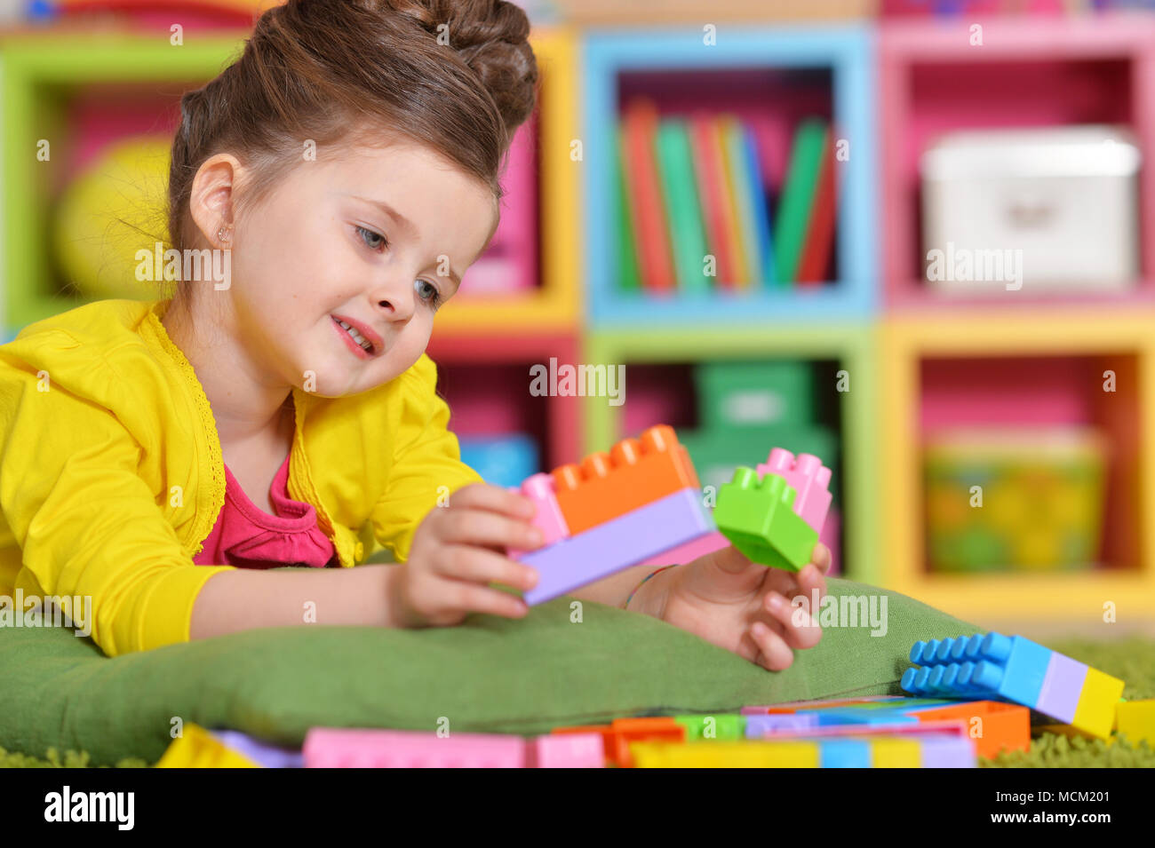girl playing with plastic blocks Stock Photo - Alamy