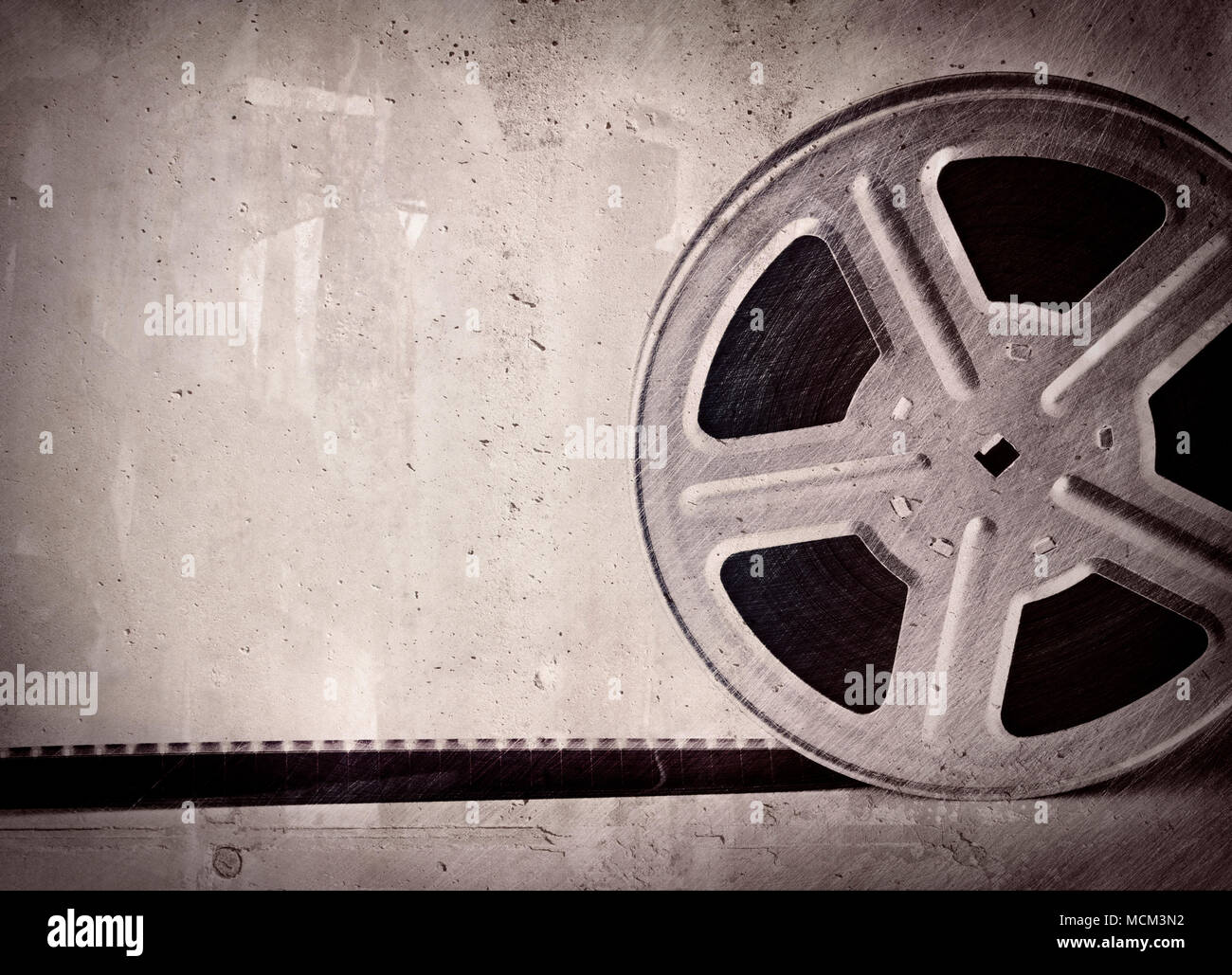 Old motion picture film reel on gray concrete background Stock Photo