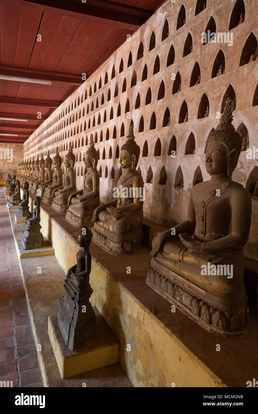View of many old and aged Buddha statues at the Wat Si Saket (Sisaket) temple's cloister in Vientiane, Laos. Stock Photo