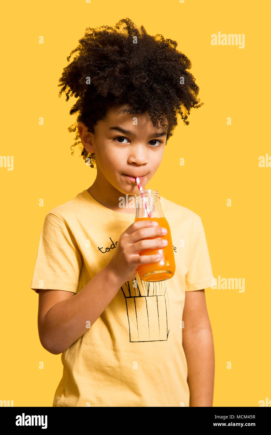 Cute Afro Little Boy Drinking Orange And Carrot Juice From A