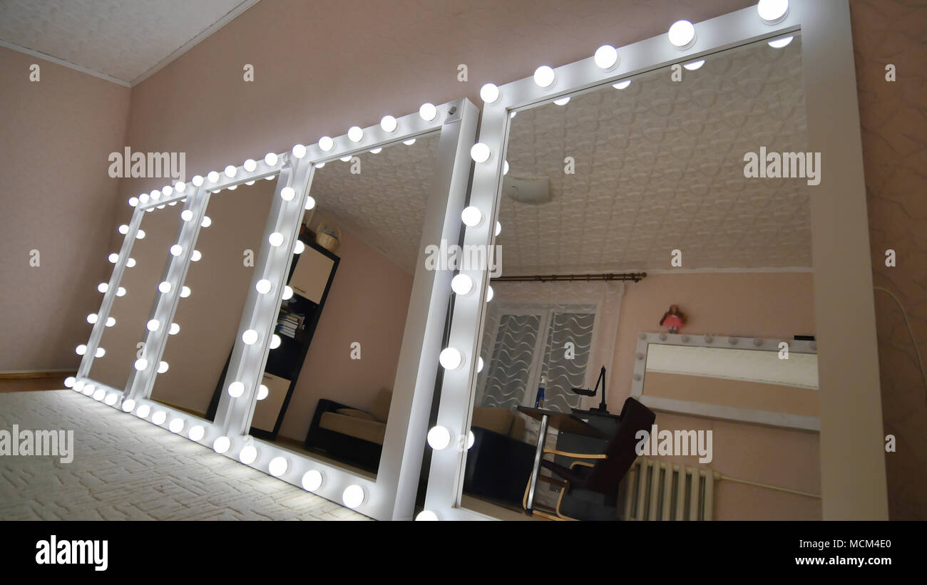 Four makeup mirrors stand in the room and are lit Stock Photo Alamy