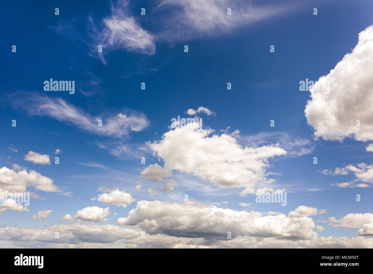 white fluffy clouds on blue sky at sunny day Stock Photo - Alamy
