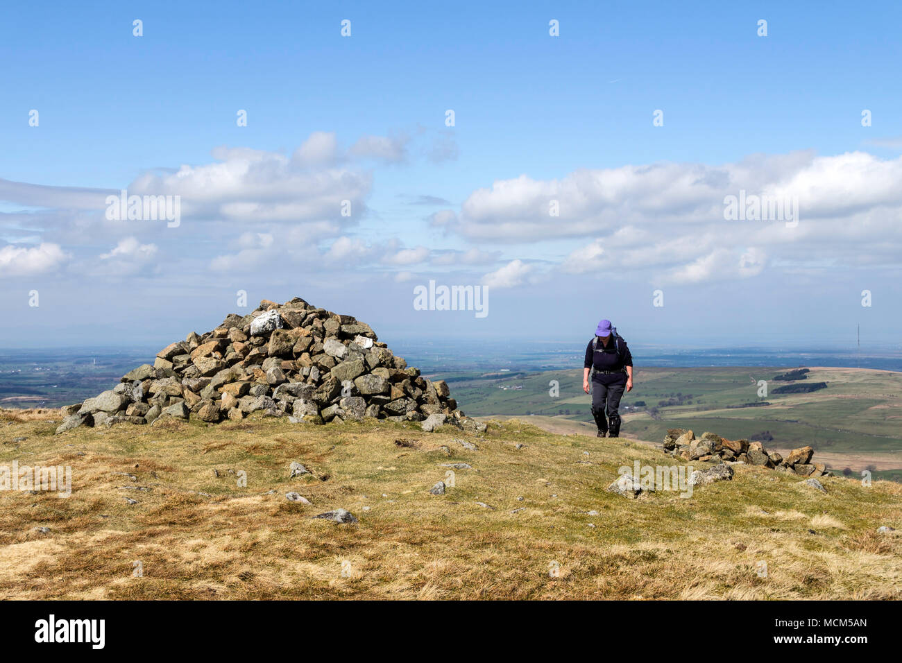 Walker Approaching the Summit Cairn on Brae Fell, Uldale Fells, Lake District, Cumbria, UK Stock Photo
