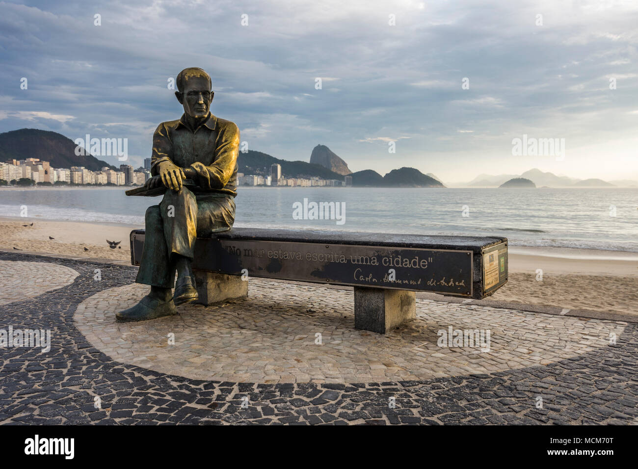 Statue of Carlos Drummond de Andrade (Brazilian poet) seen during sunrise in Copacabana Beach, Rio de Janeiro, Brazil Stock Photo