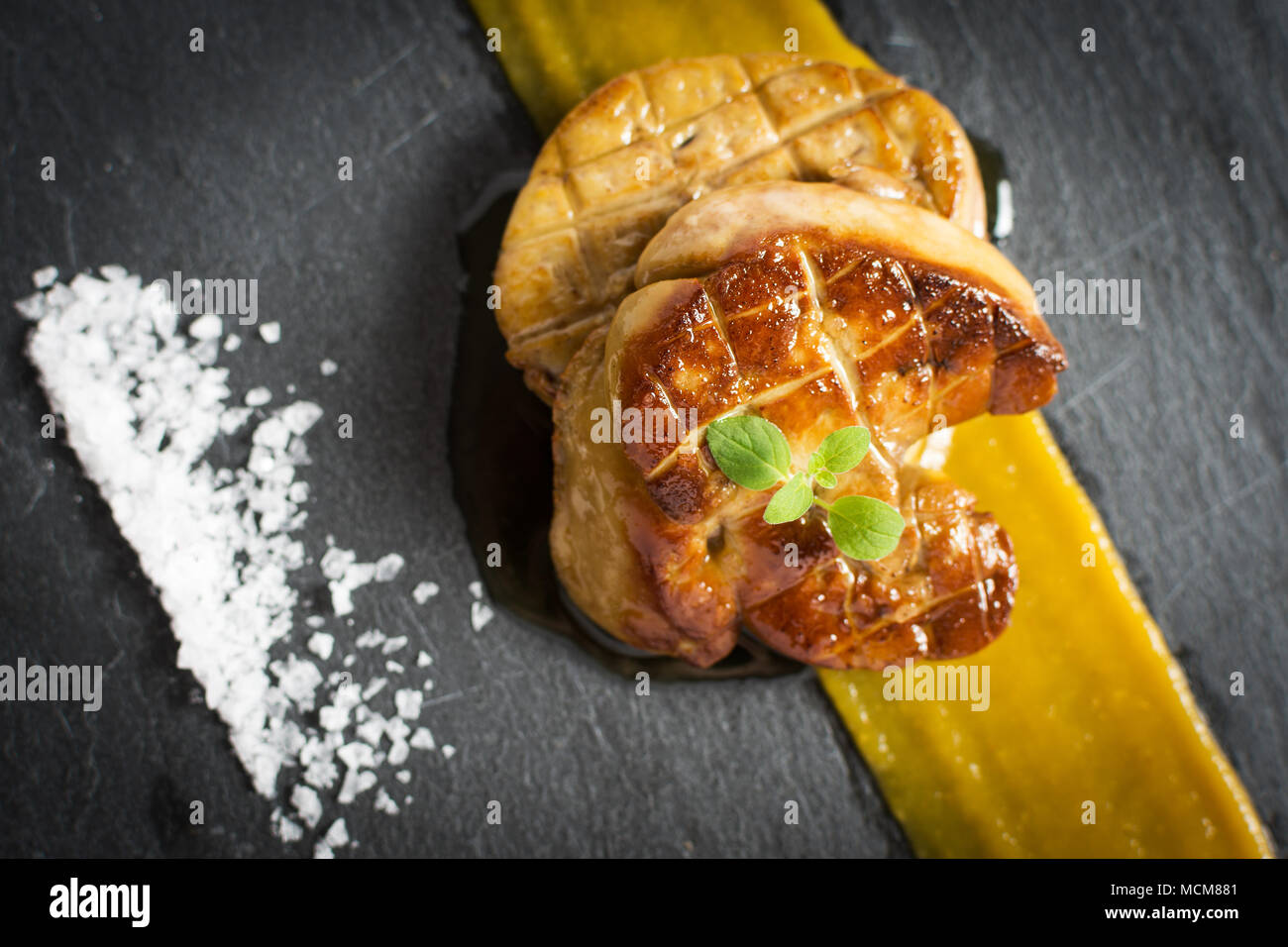 Fried Goose Liver. Foie Gras with Mango Puree. Stock Photo