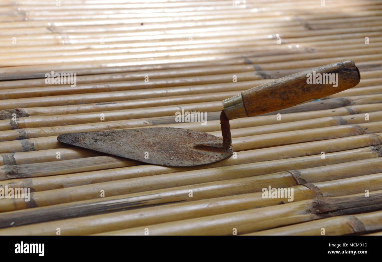 steel trowel on bamboo Stock Photo Alamy