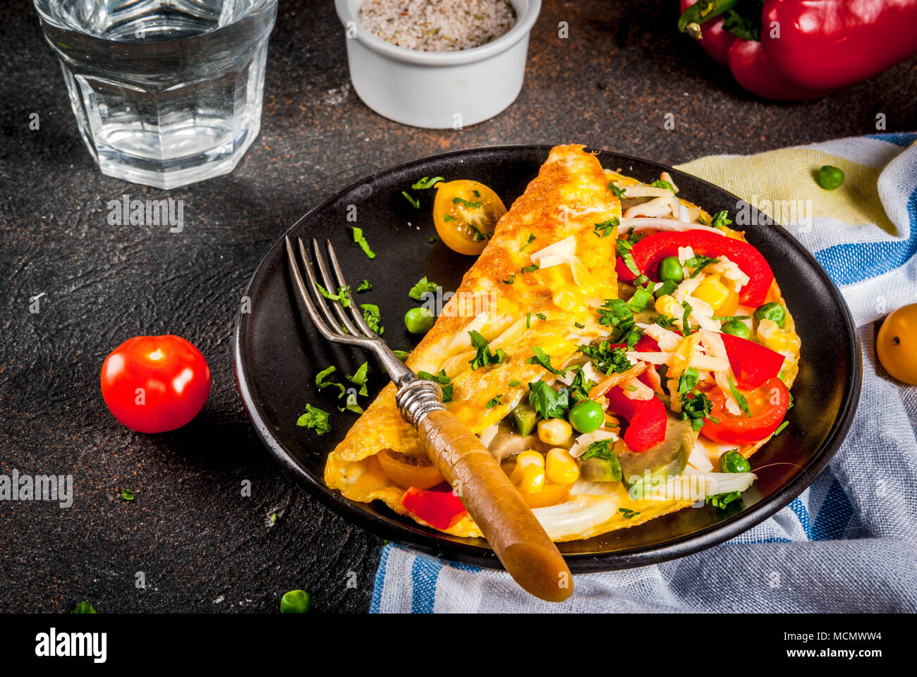 Healthy breakfast food, Stuffed egg omelette with vegetable, dark concrete background copy space Stock Photo
