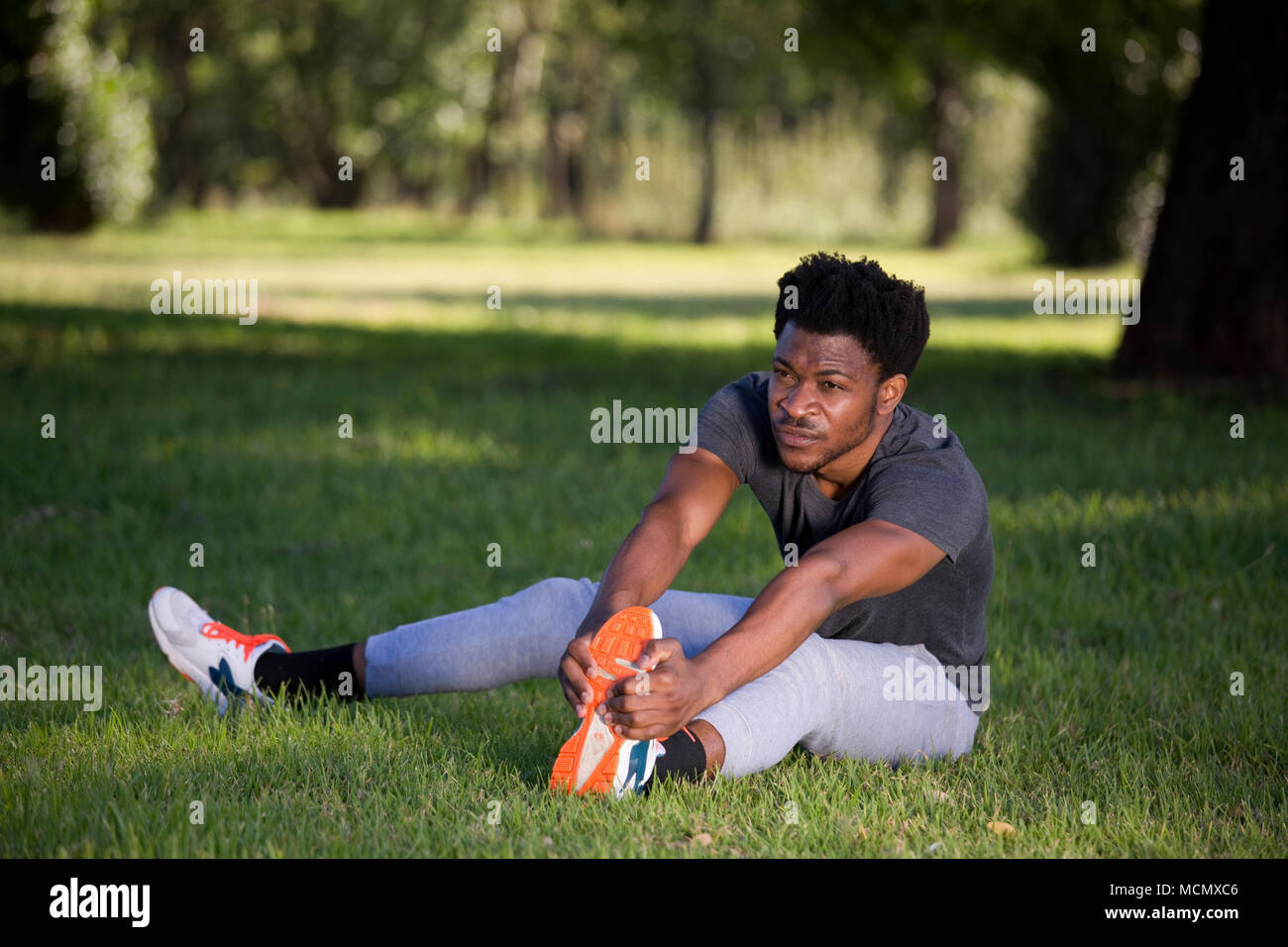 Man stretching in a park Stock Photo