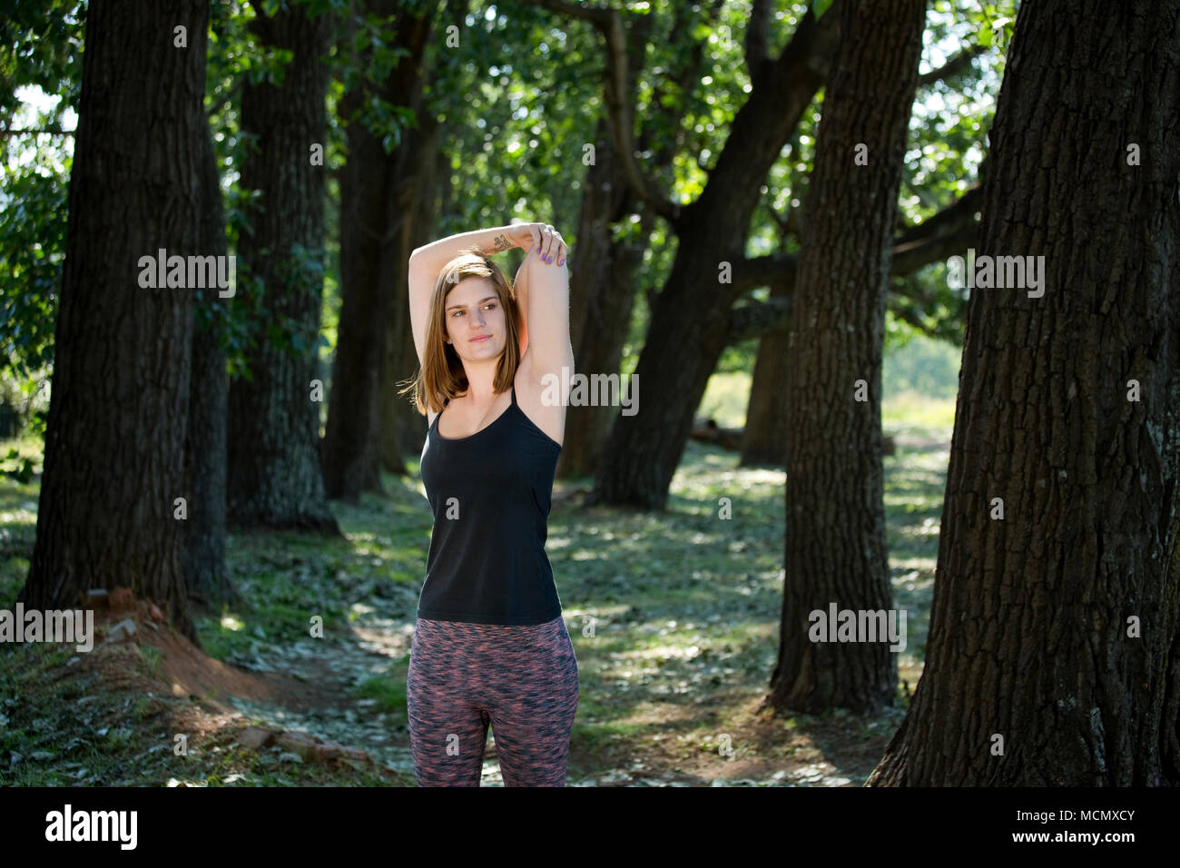 Woman stretching in a park Stock Photo