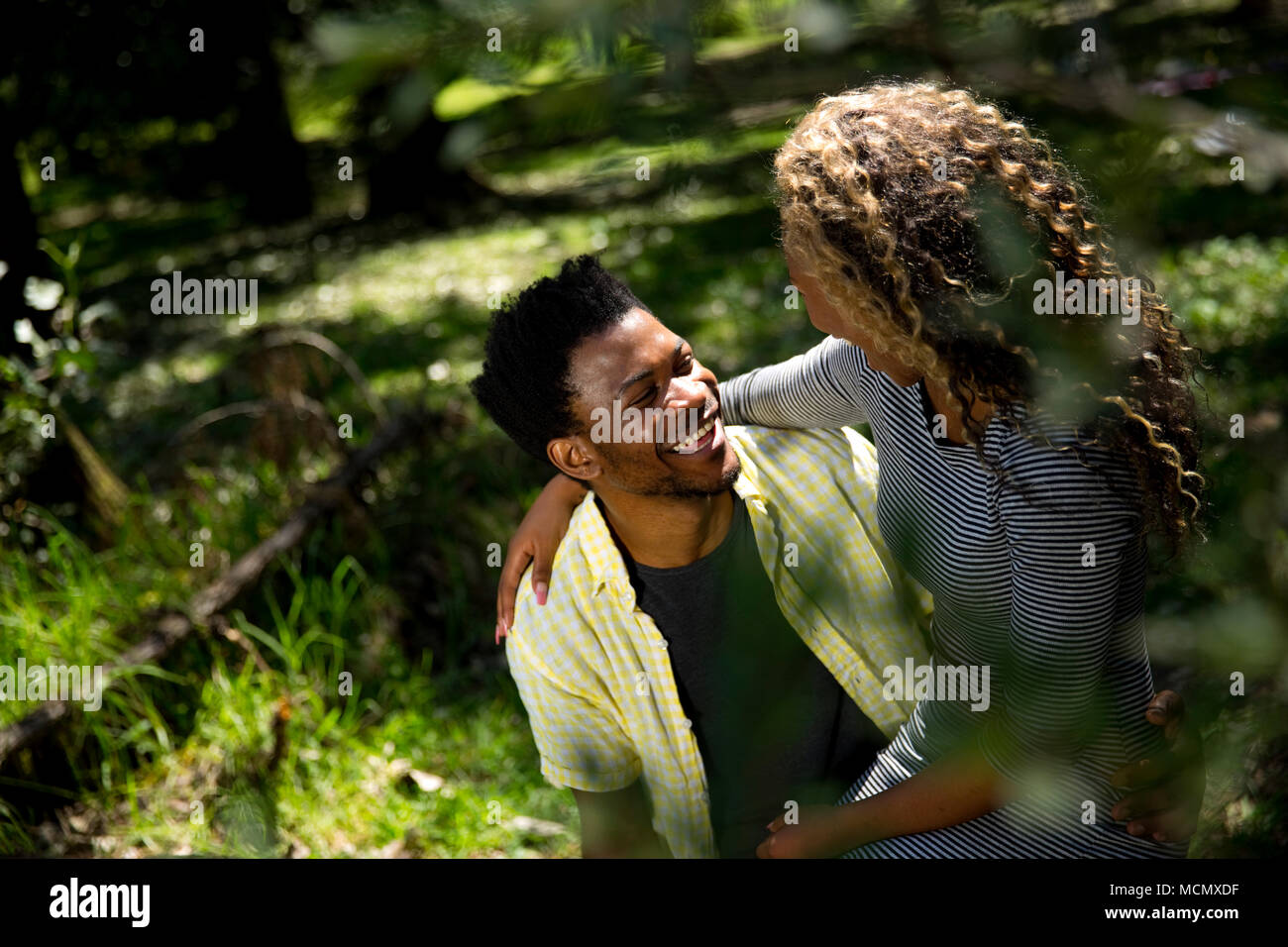 Couple embracing one another in a park Stock Photo