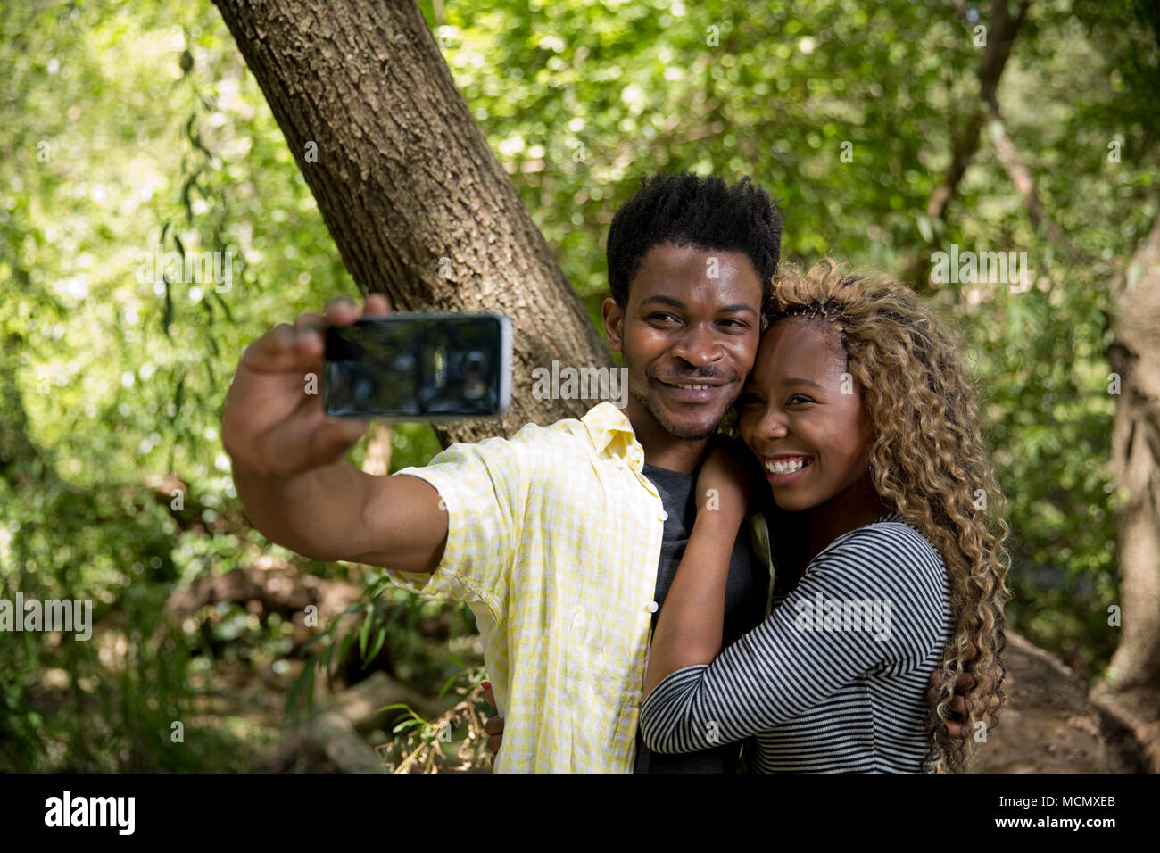 Couple taking a selfie in a park Stock Photo