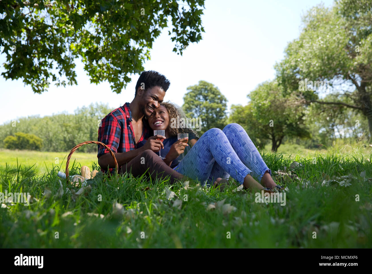 Couple enjoying a picnic in a park Stock Photo
