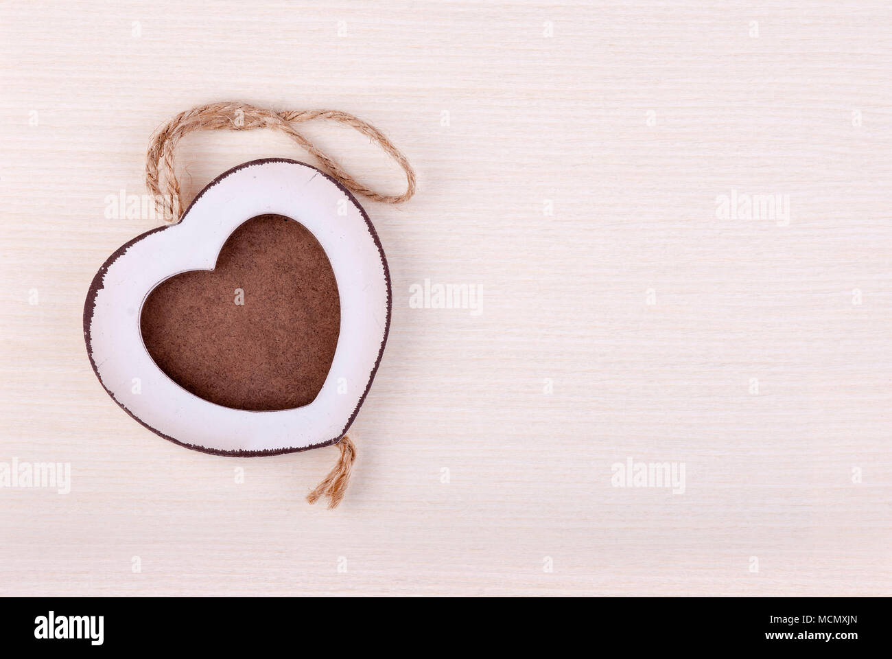 Photo frame in wood heart shape on birch wood background. Stock Photo